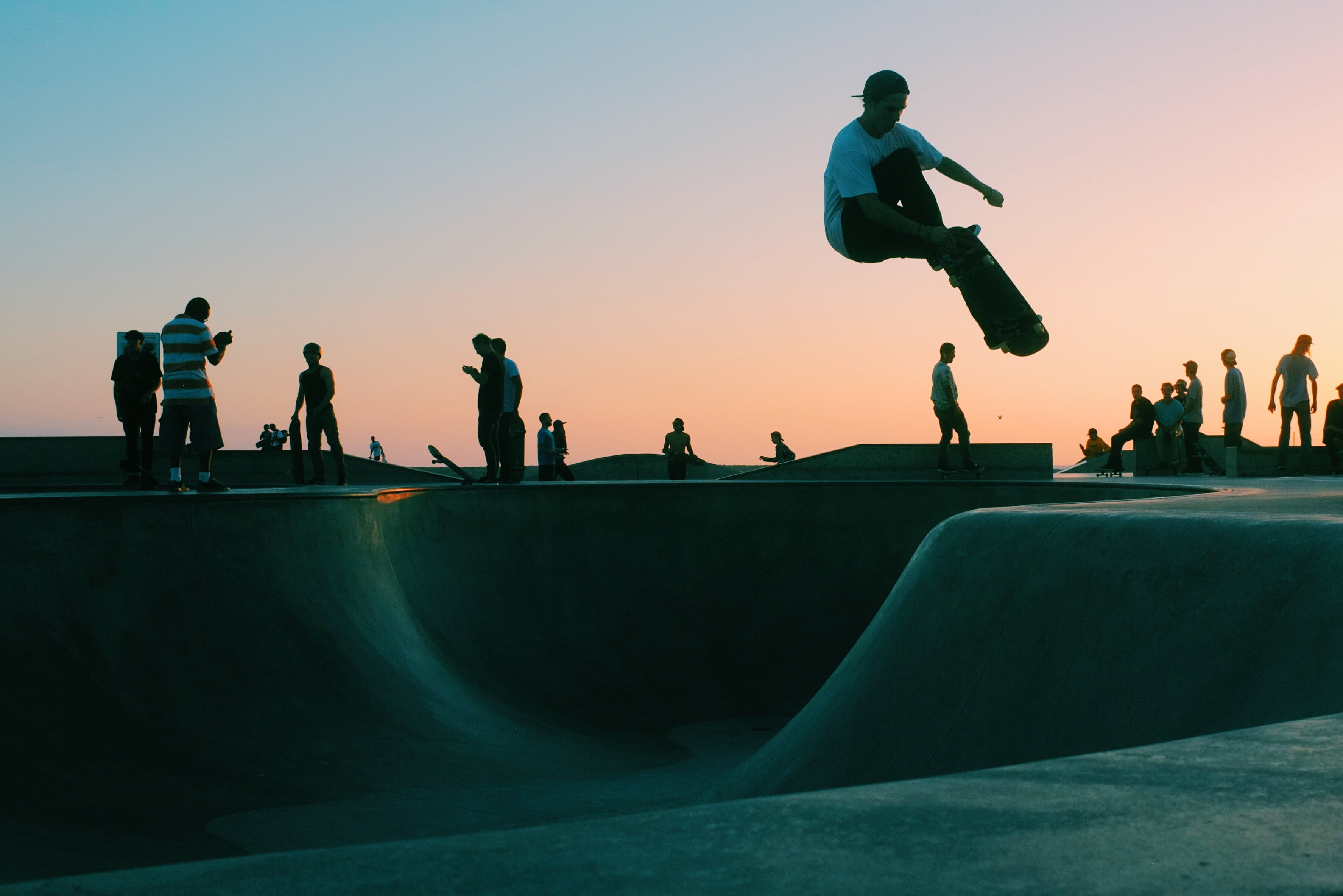 sports ramp, sunset, real people, silhouette, man, park, leisure activity, water, skateboarding, skill, skateboard park, sport, men, clouds, 2K, group of people, HD Wallpaper