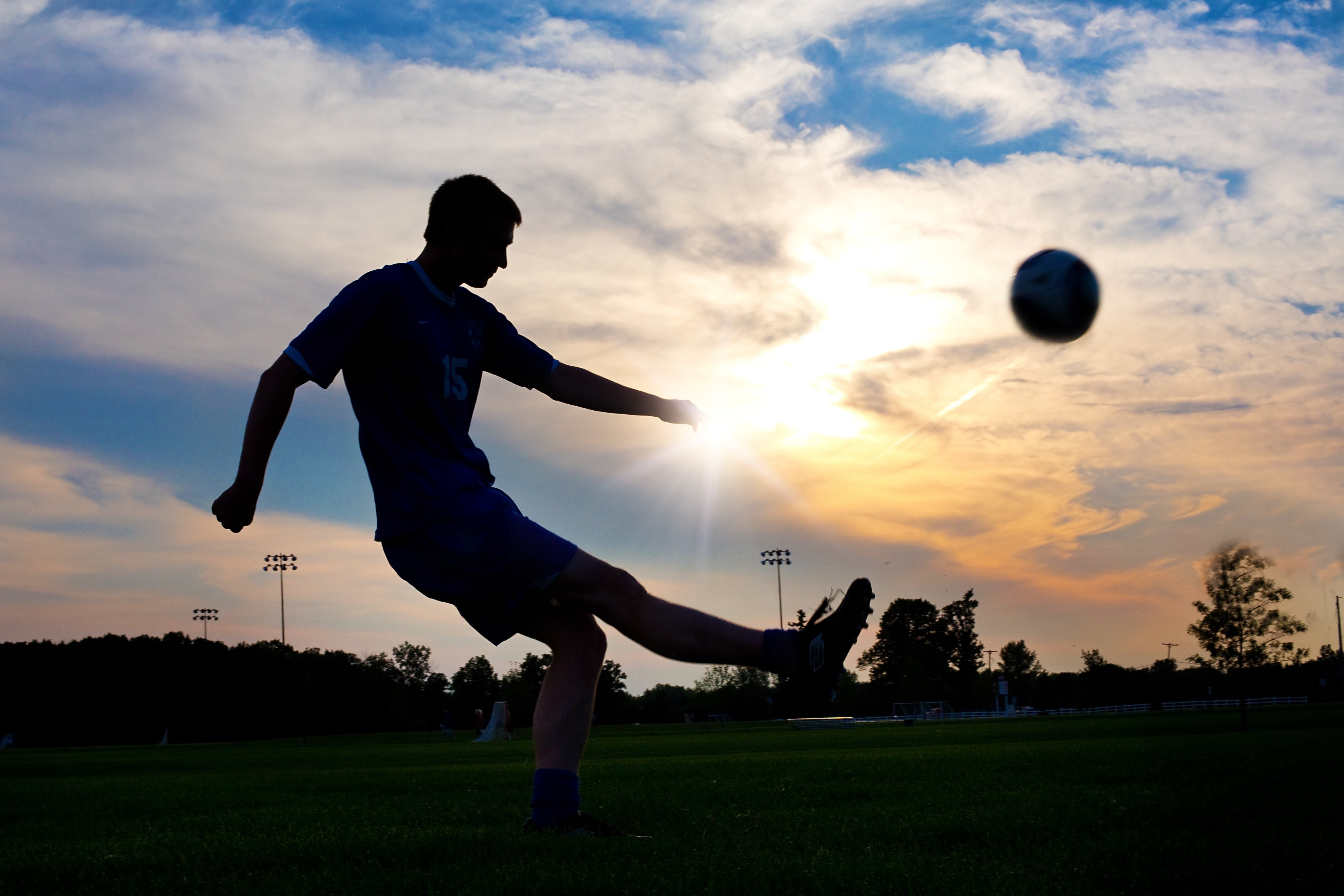 outdoors, grass, ball, skill, player, man, sky, 5K, vitality, leisure activity, soccer, human arm, sunset, one person, kicking, men, silhouette, real people, HD Wallpaper