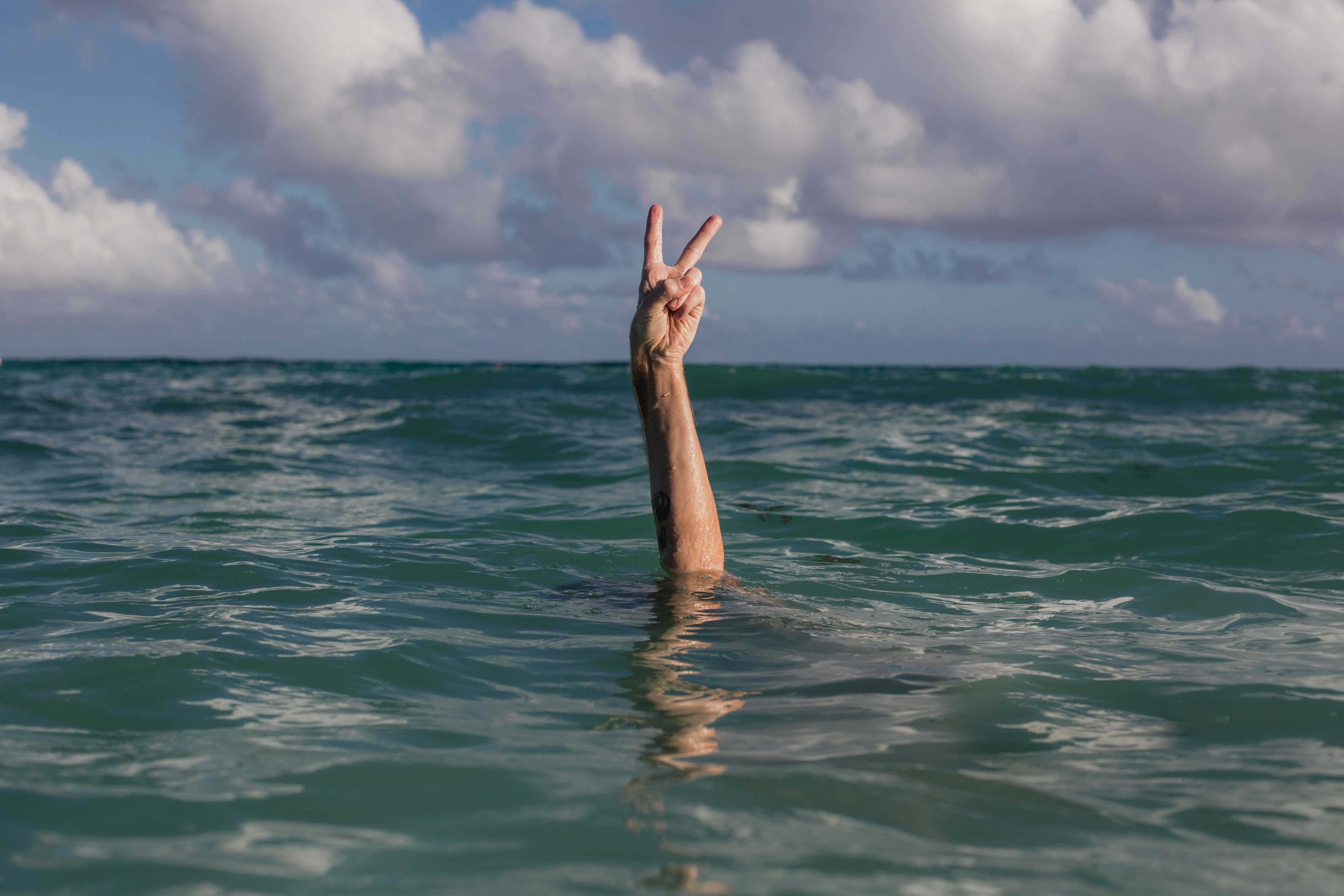 Earth, hand, sign, cloud - sky, finger, Ocean, real people, outdoors, body part, Beaches, 4K, horizon over water, day, human limb, Cloud, Seasons, Sky, HD Wallpaper
