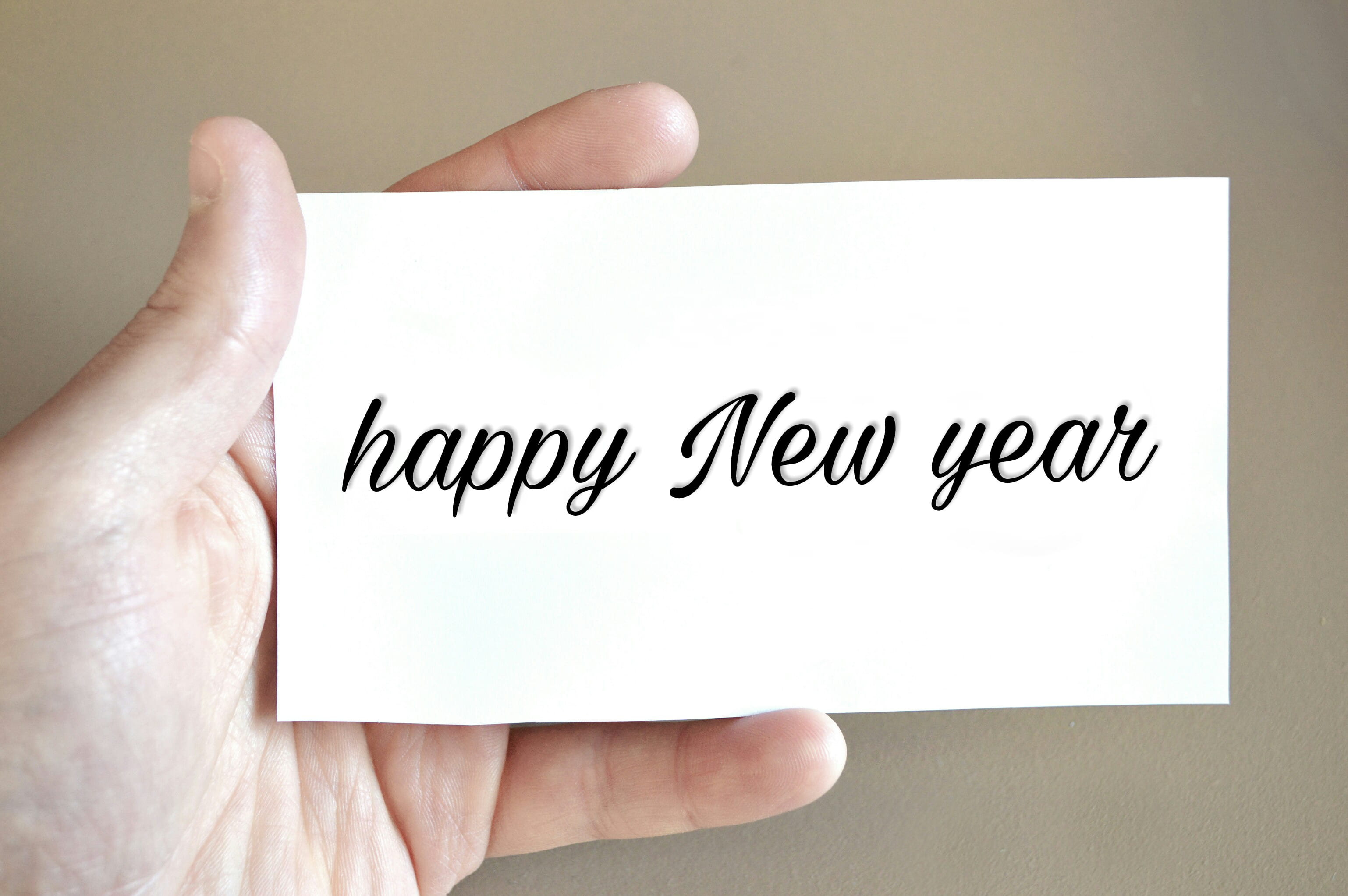 simple, happy, reads, greeting, new, year, human hand, hand, studio shot, people, close-up, postage, white, text, indoors, message, human finger, new year eve, HD Wallpaper