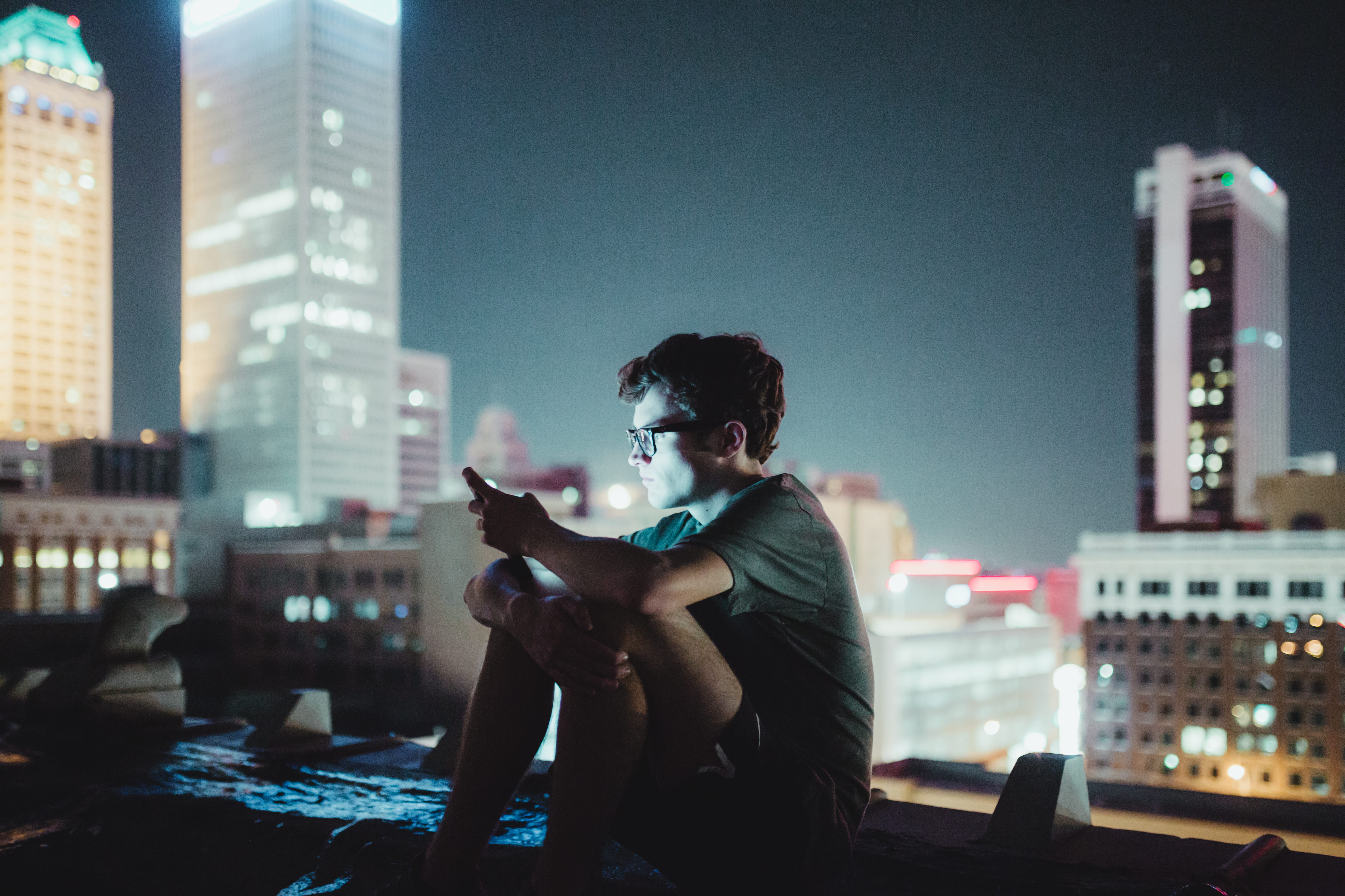 sitting, rooftoping, 5K, male, building exterior, office building exterior, roof, full length, outdoors, shining, city, night, wireless technology, shirt, HD Wallpaper