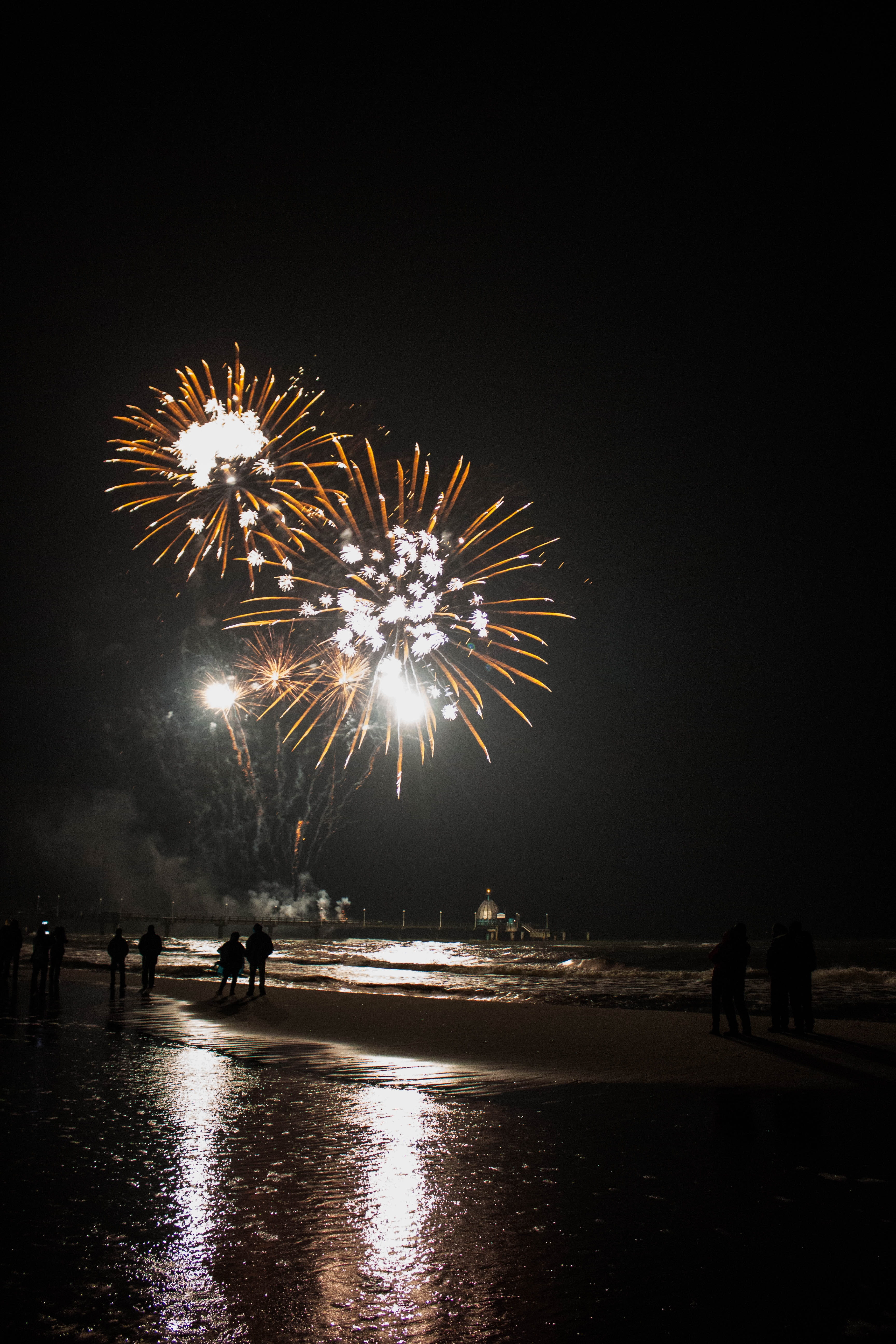 real people, firework, event, sky, sparks, arts culture and entertainment, water, beach, exploding, glowing, 5K, firework - man made object, motion, night, Phone HD Wallpaper