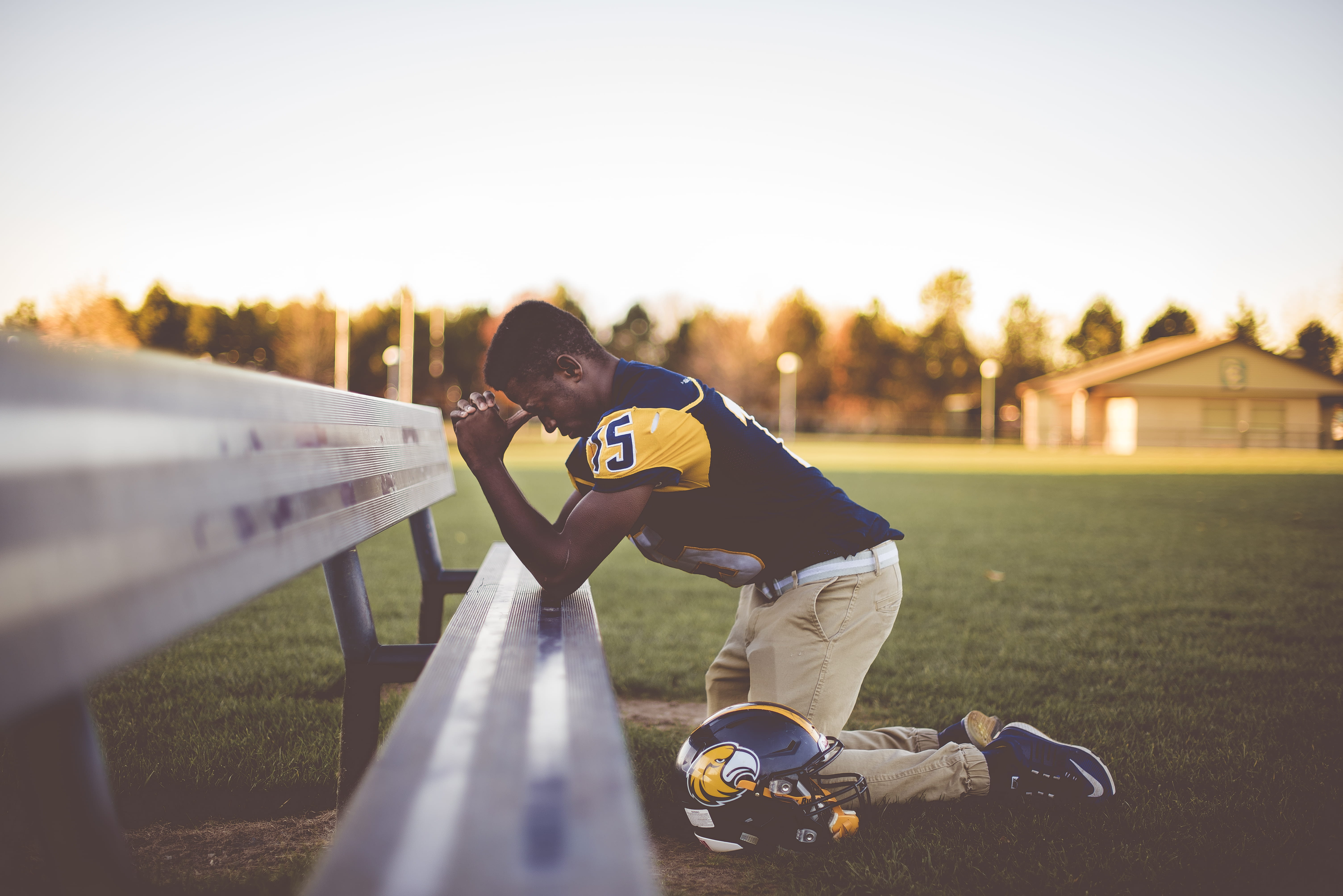 nature, grass, kneeling, ground, lifestyles, prayer, teen, outdoors, jersey, males, teenager, hand, field, sunlight, sports clothing, park, athlete, pray, HD Wallpaper