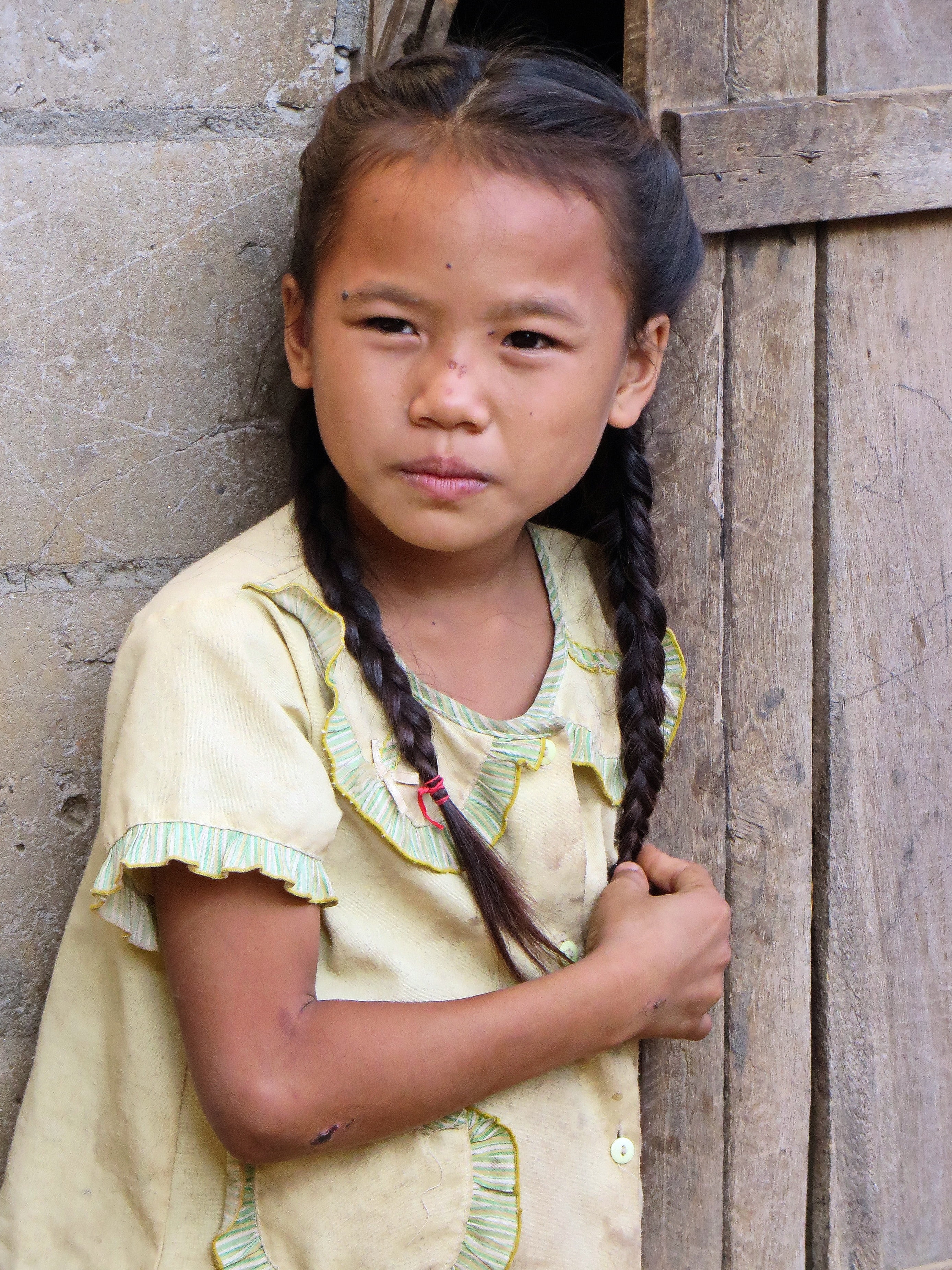 real people, little girl, cute, village, child, laos, childhood, portrait, looking at camera, casual clothing, women, standing, females, wood - material, Phone HD Wallpaper