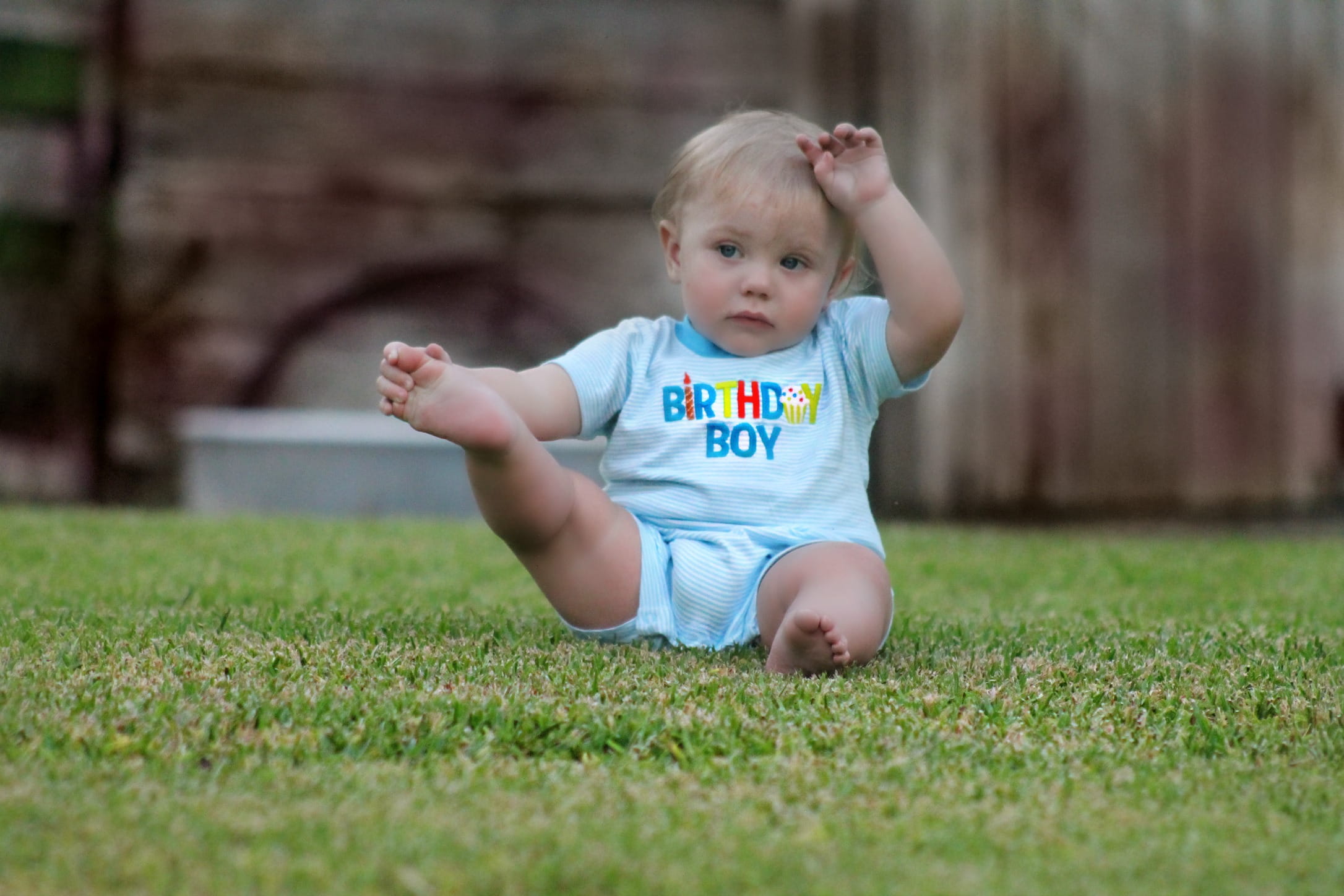 green grass, human arm, boy, sitting, photography, day, real people, in blue, adorable, 1080P, full length, onesie, outdoors, child, grass, expression, HD Wallpaper