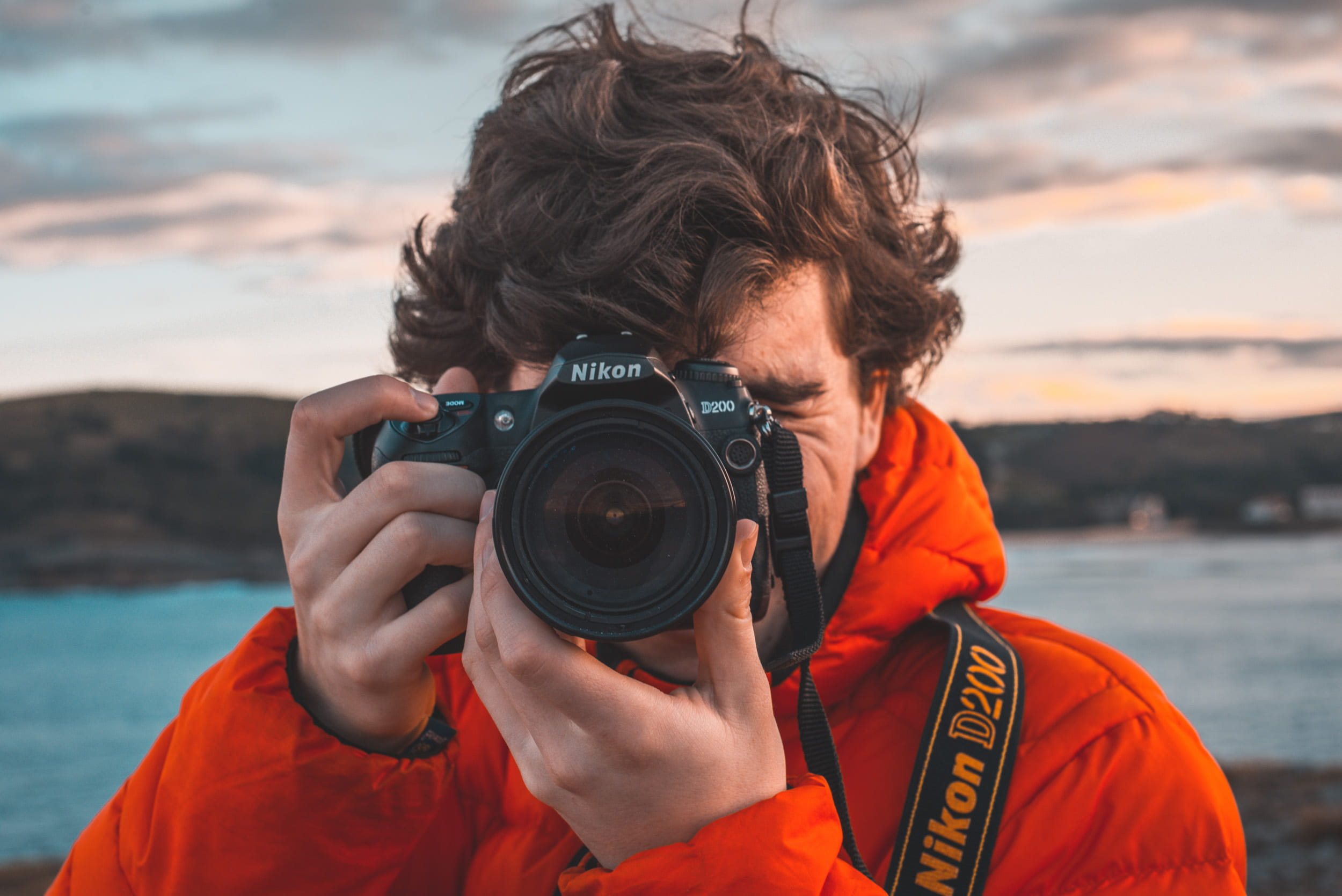 water, sea, leisure activity, camera - photographic equipment, adult, digital camera, real people, man, photographic equipment, red coat, slr camera, headshot, HD Wallpaper