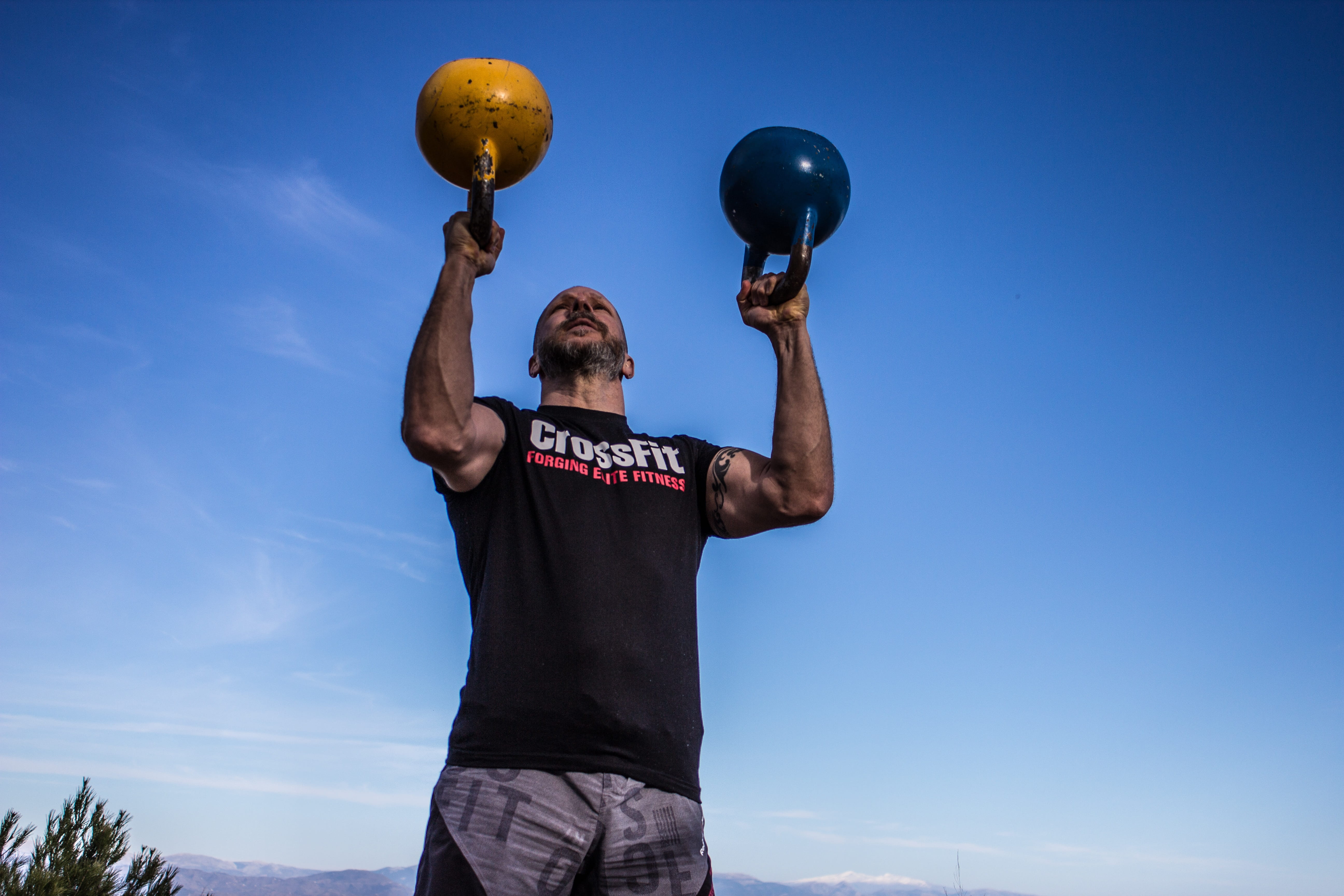 men, taco fleur, human limb, standing, kettlebells, human arm, day, holding, leisure activity, arms raised, low angle view, lifestyles, press, cavemantraining, HD Wallpaper