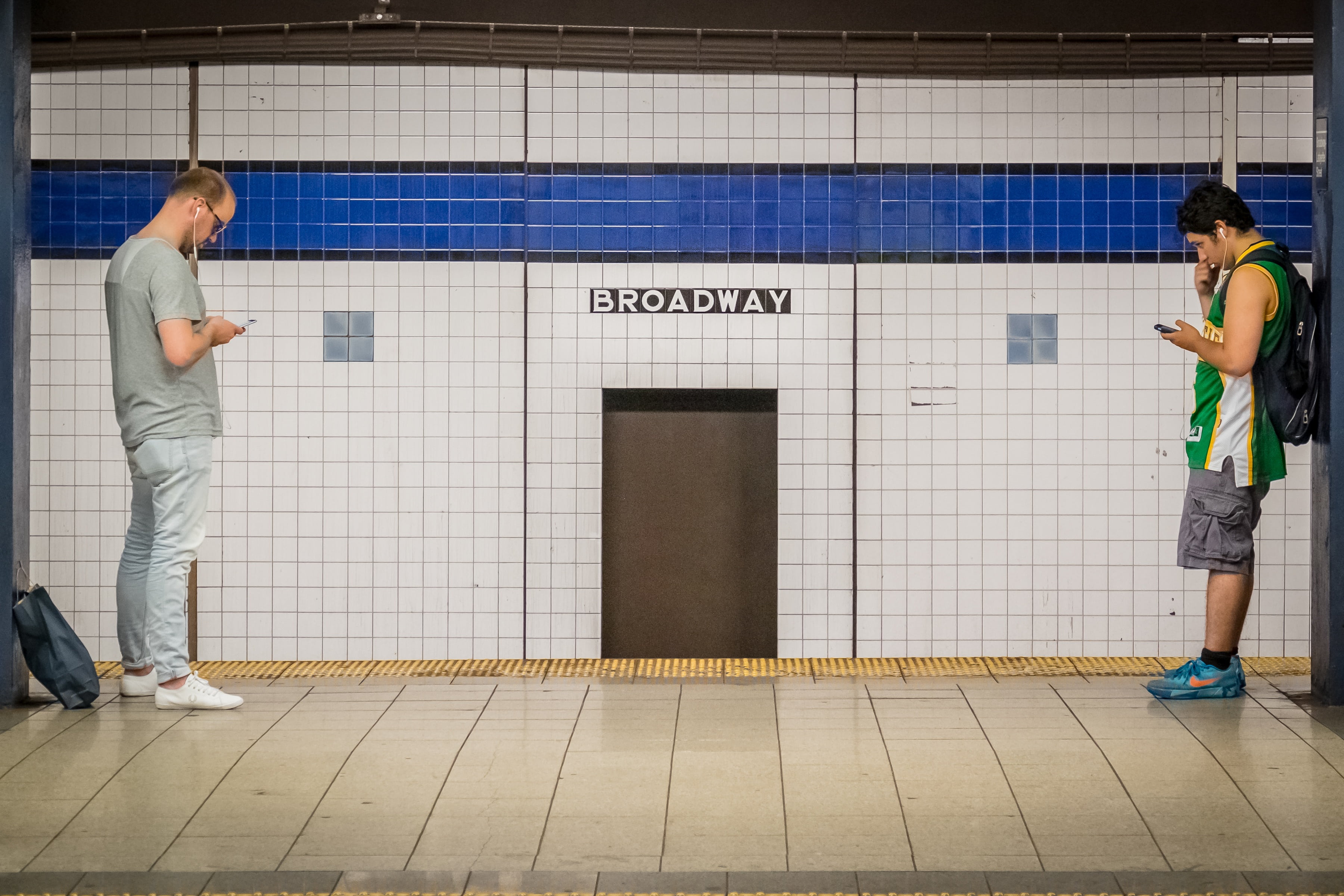 standing, sign, metro, two people, new, full length, subway station, manhattan, communication, text, ear phone, architecture, 2K, men, listen, waiting, HD Wallpaper