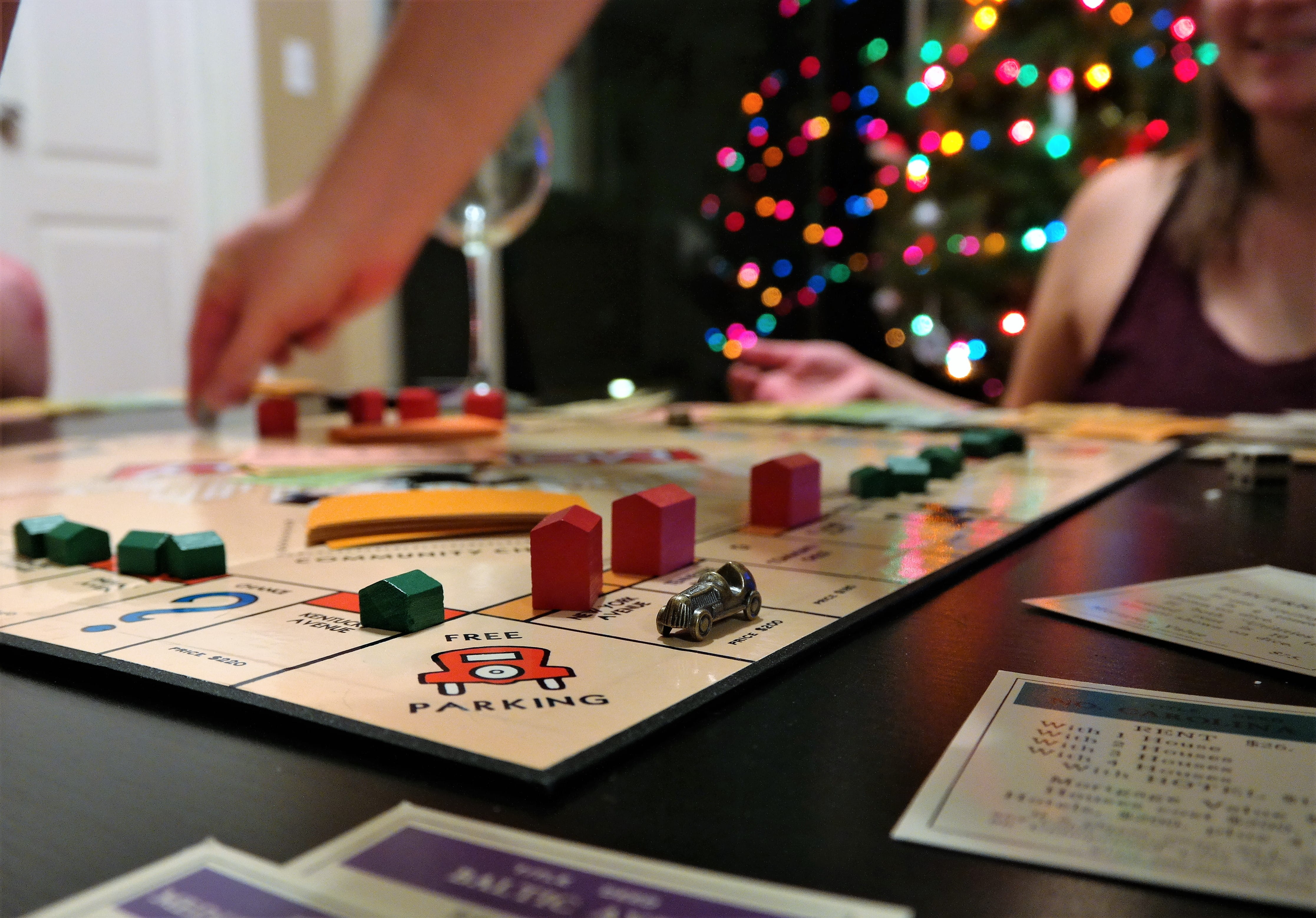 selective focus, adult, indoors, table, hand, monopoly, 4K, games, human hand, young adult, midsection, creativity, leisure activity, focus on foreground, HD Wallpaper