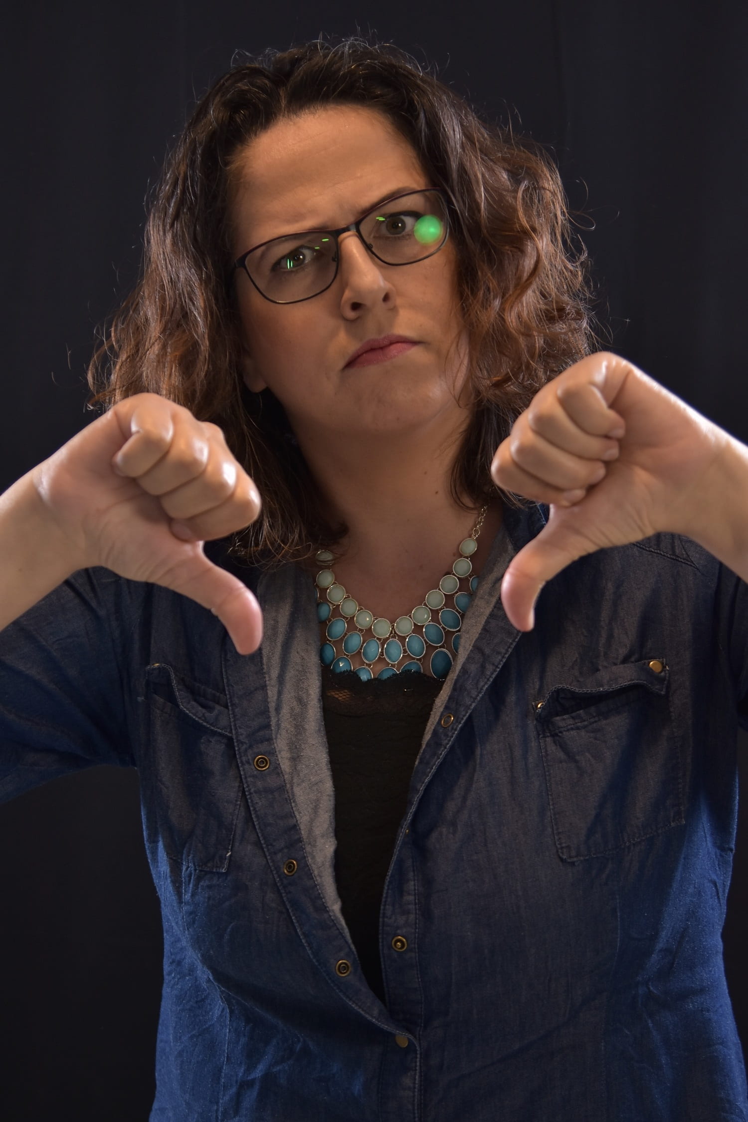 indoors, bad, woman, hand sign, upset, thumb, beautiful woman, eyeglasses, studio shot, sign, no, 1080P, one person, dislike, casual clothing, lifestyles, Phone HD Wallpaper