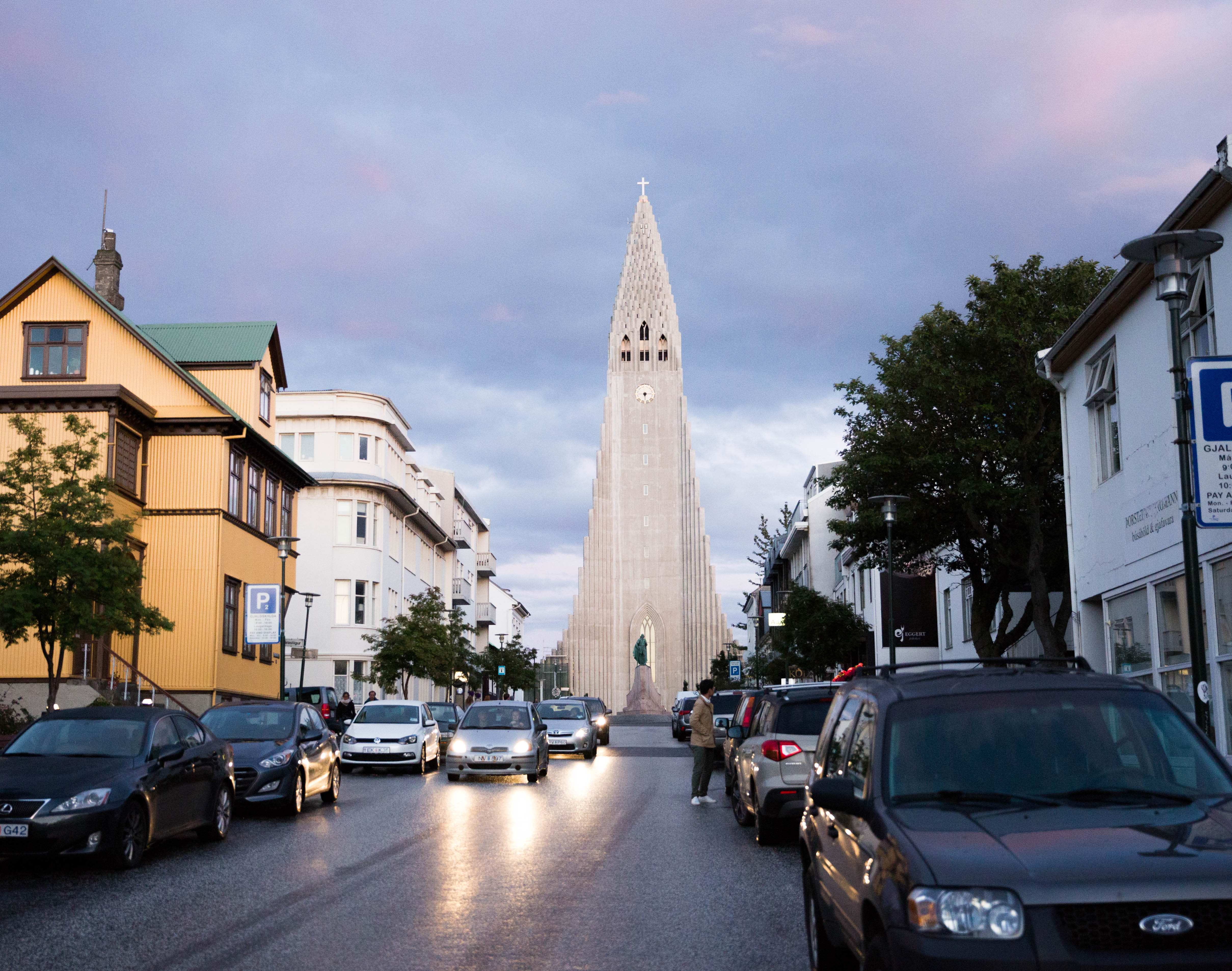 motor vehicle, street, cloud - sky, mode of transportation, plant, nature, road, reykjavik, building, city, tree, 4K, sky, hallgrimskirkja, architecture, HD Wallpaper