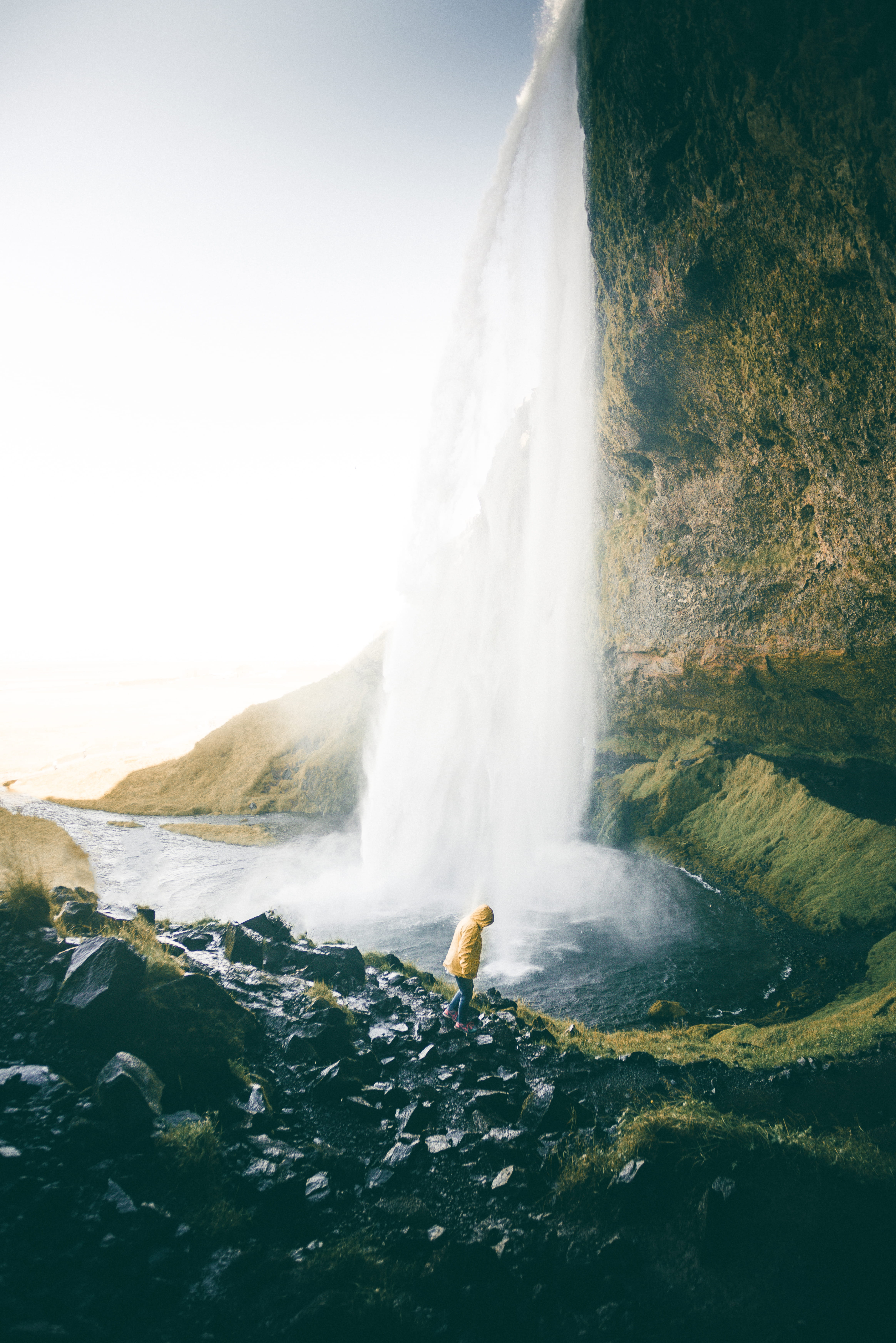 stone, tourism, blue, waterfalls, landscape, sky, adventure, skogafoss Waterfall, sea, majestic, near, beauty In Nature, motion, rain jacket, no People, Phone HD Wallpaper
