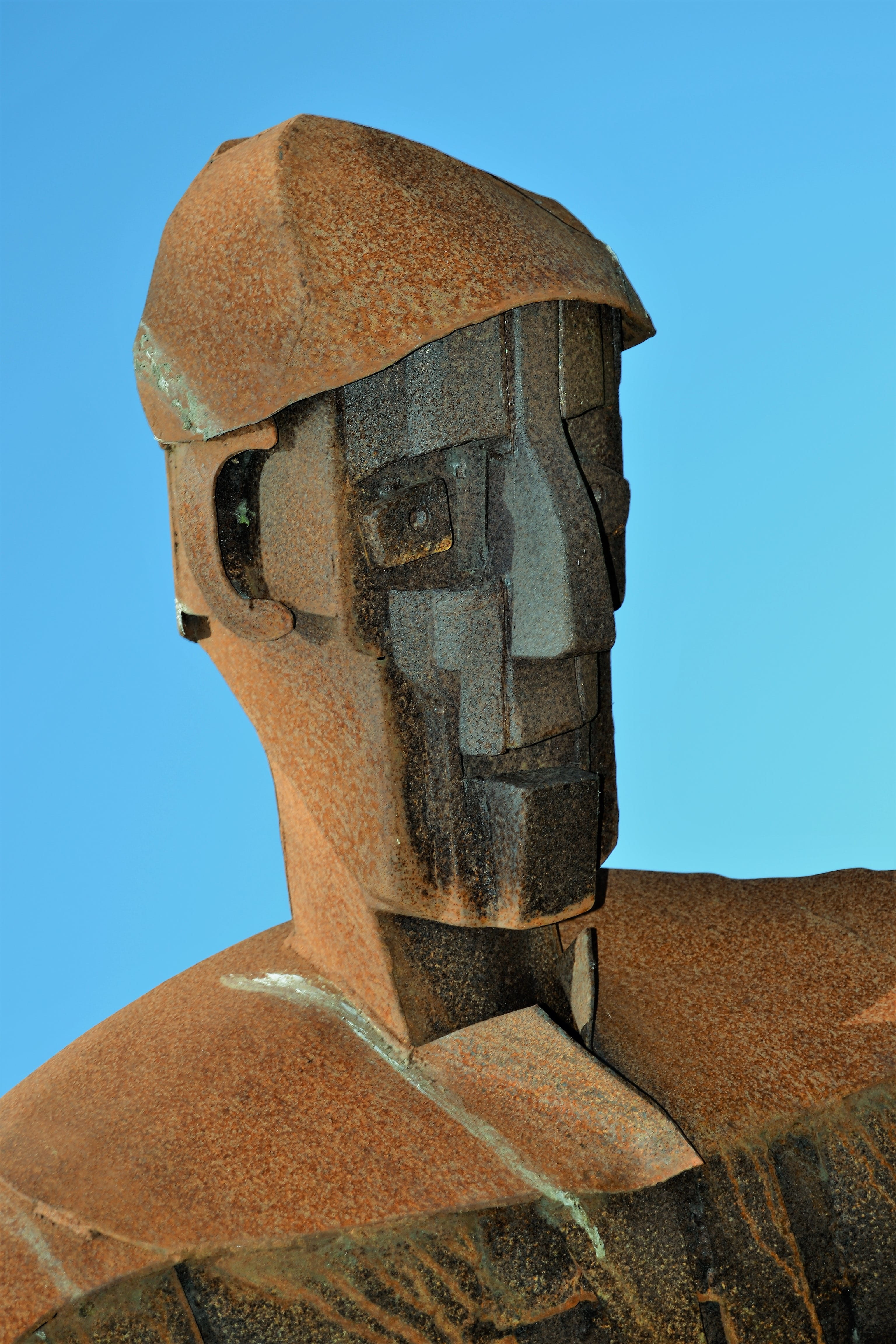 clear sky, face, outdoors, Metal, sky, portrait, stone, fire, tattoo, iron, Iron, solid, eyes, relief, representation, low angle view, statue, blue, Man, Phone HD Wallpaper