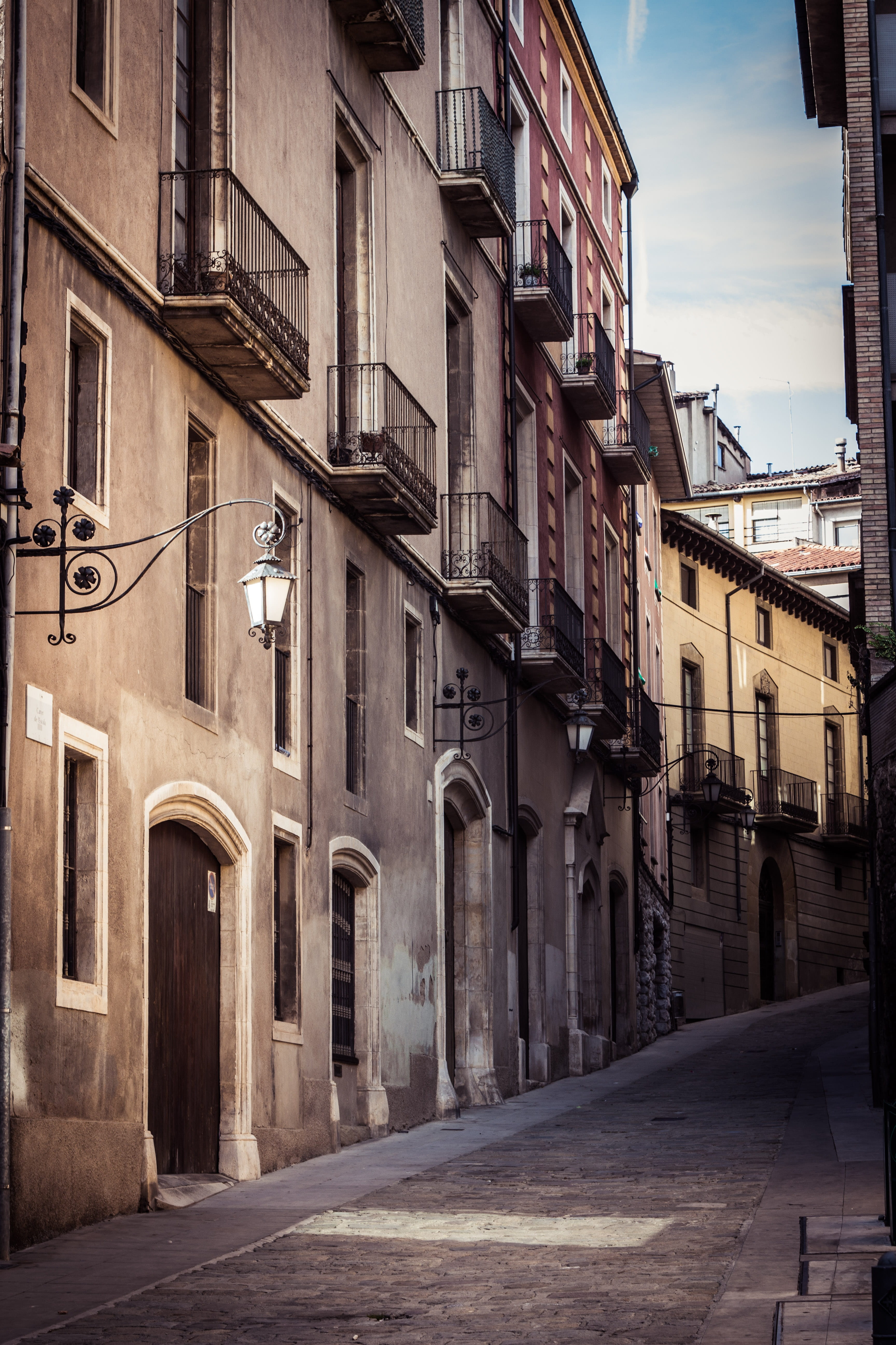 building exterior, city, street, residential district, vic, building, road, long, alley, transportation, barcelona, built structure, outdoors, street light, Phone HD Wallpaper