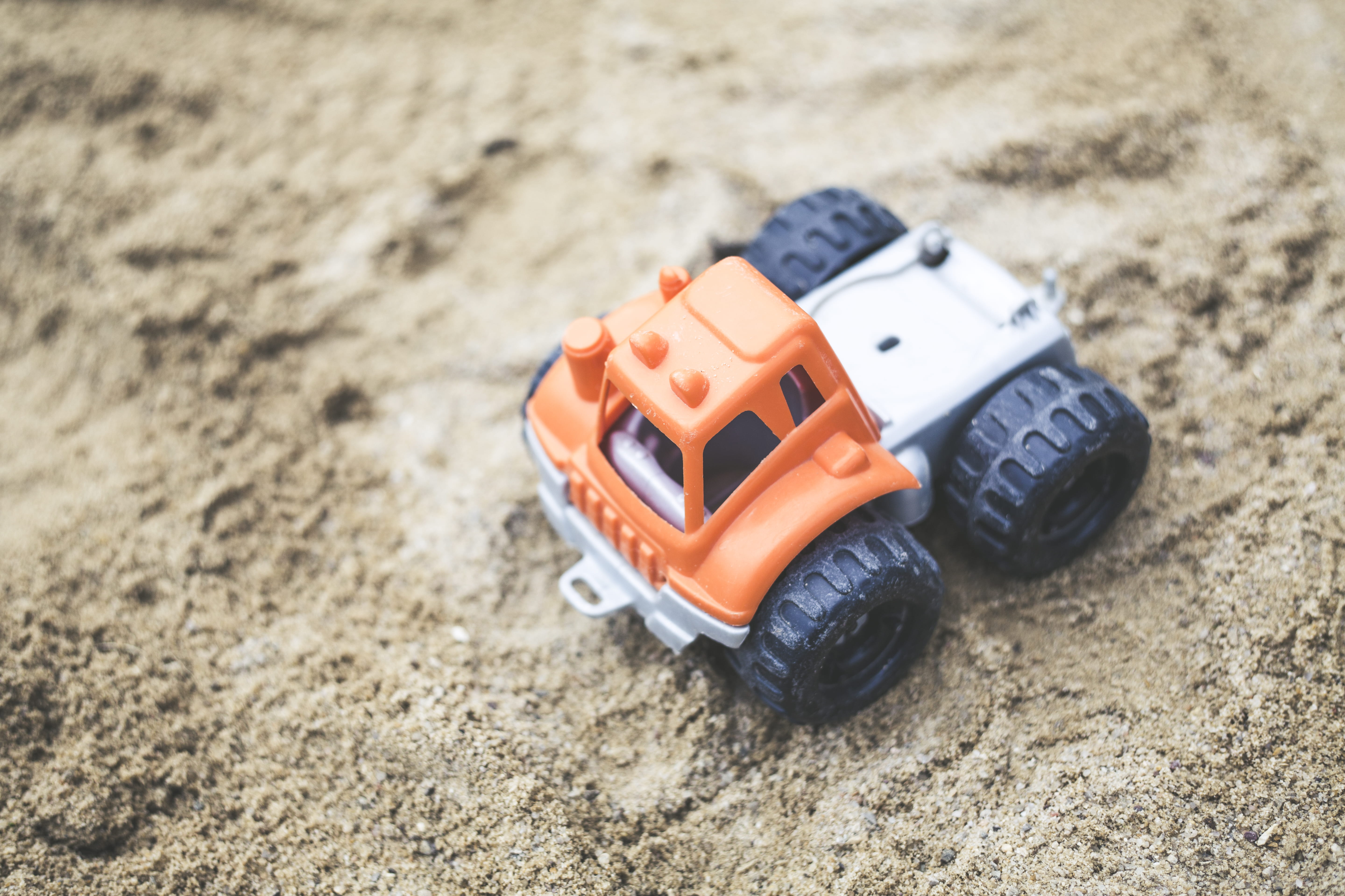 high angle view, small, toy car, ground, little, vehicle, land, selective focus, 5K, wheels, childhood, car, close-up, daytime, nature, toy, focus on foreground, HD Wallpaper