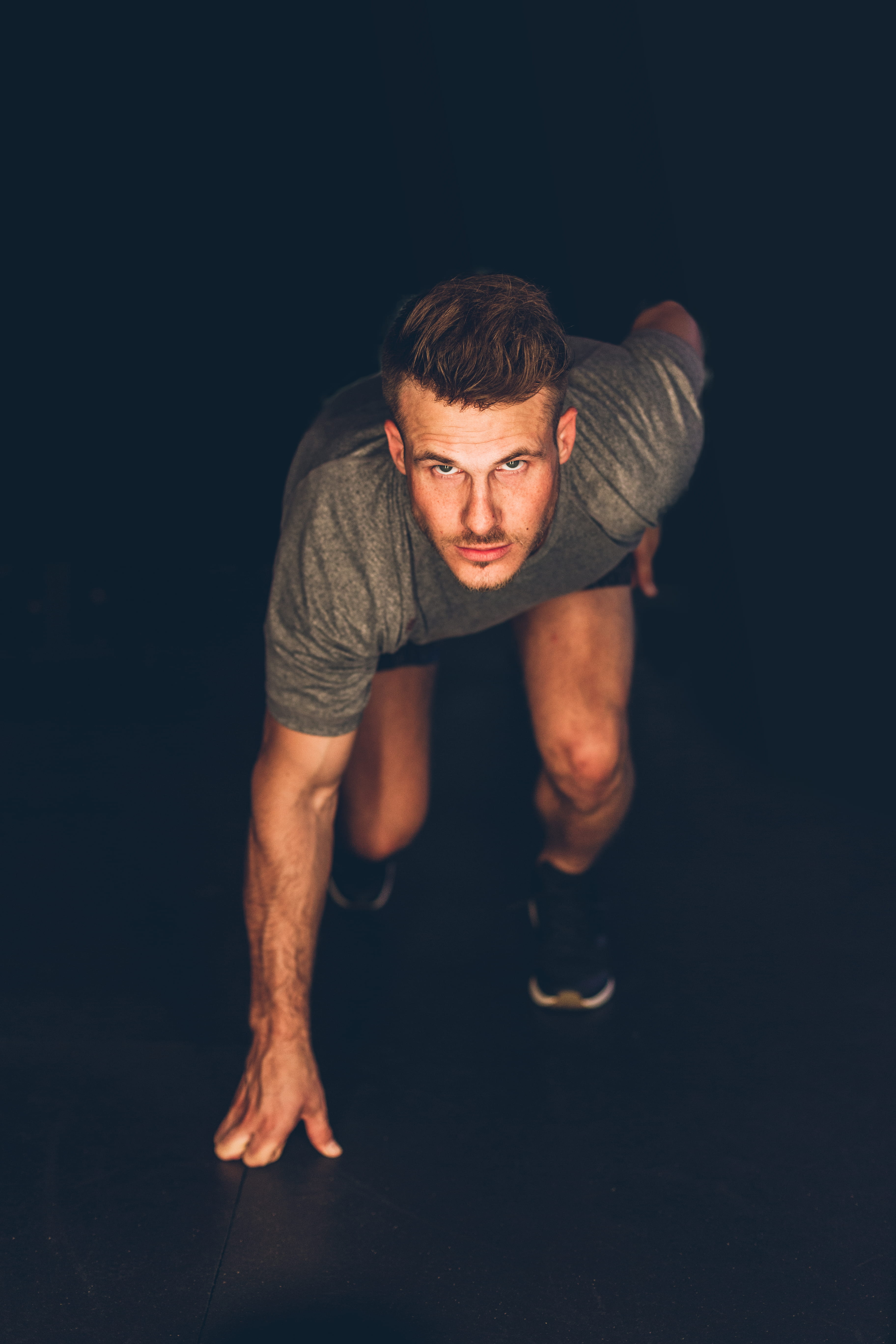 front view, running, intense, sleeve, position, mens apparel, 5K, athlete, men, healthy lifestyle, young adult, rhone, black background, males, sport, Phone HD Wallpaper