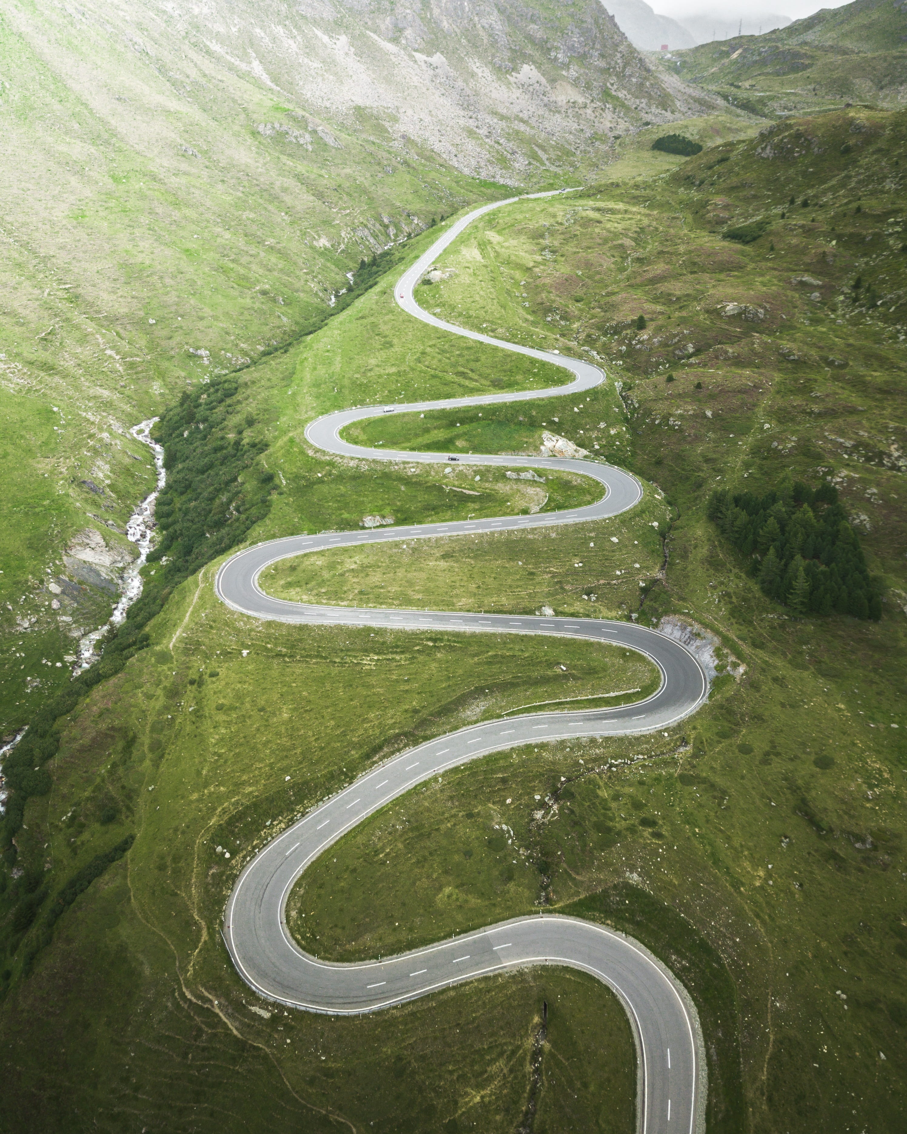 turn, curvy, high angle view, highway, non-urban scene, journey, day, alps, valley, landscape, switzerland, way, view, grass, curvy road, curve, no people, Phone HD Wallpaper