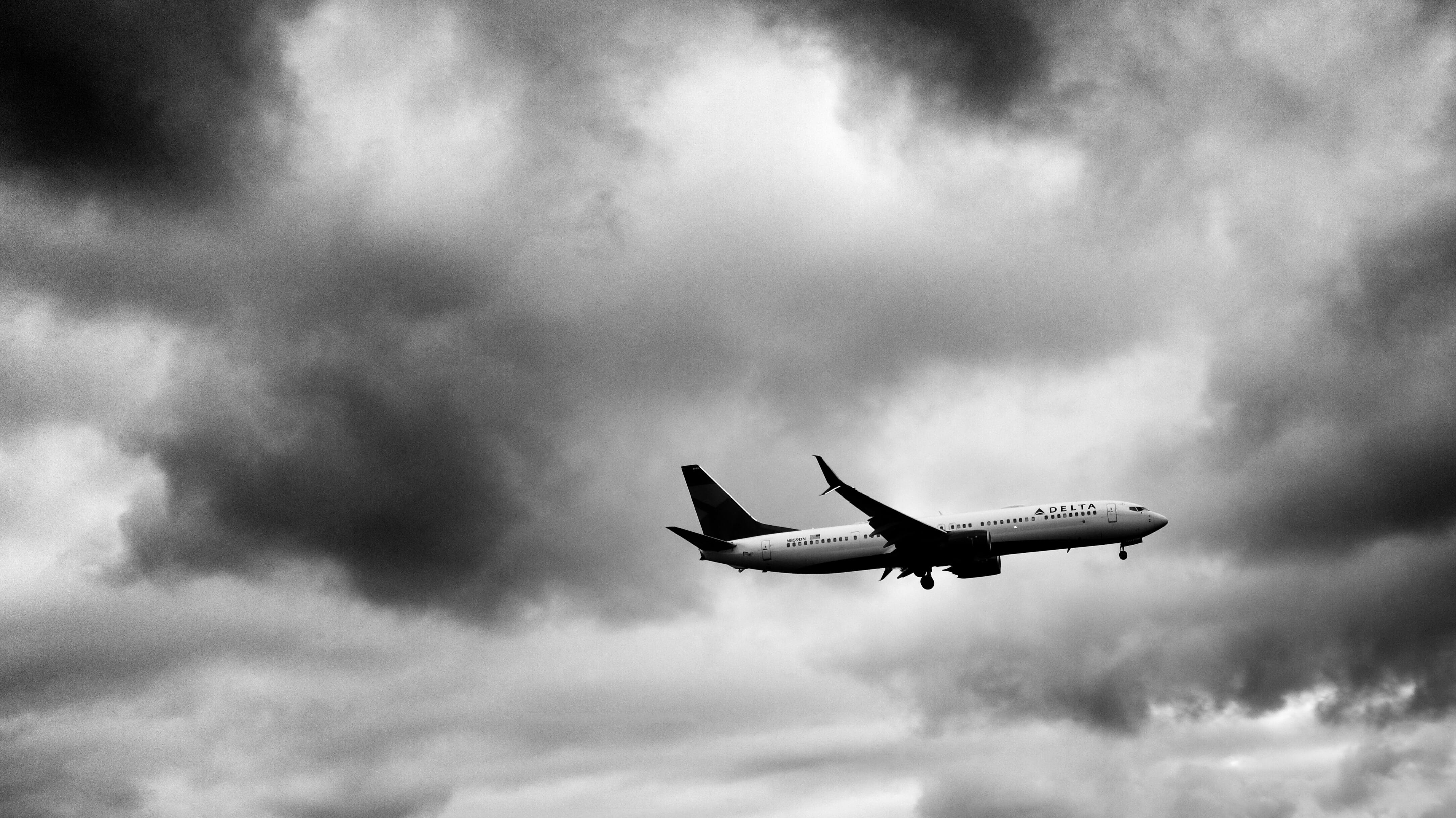 air vehicle, grayscale, photo, grey, cloud - sky, airplane, low angle view, flying, aircraft, travel, outdoors, storm, flight, black and white, sky, ominous, HD Wallpaper