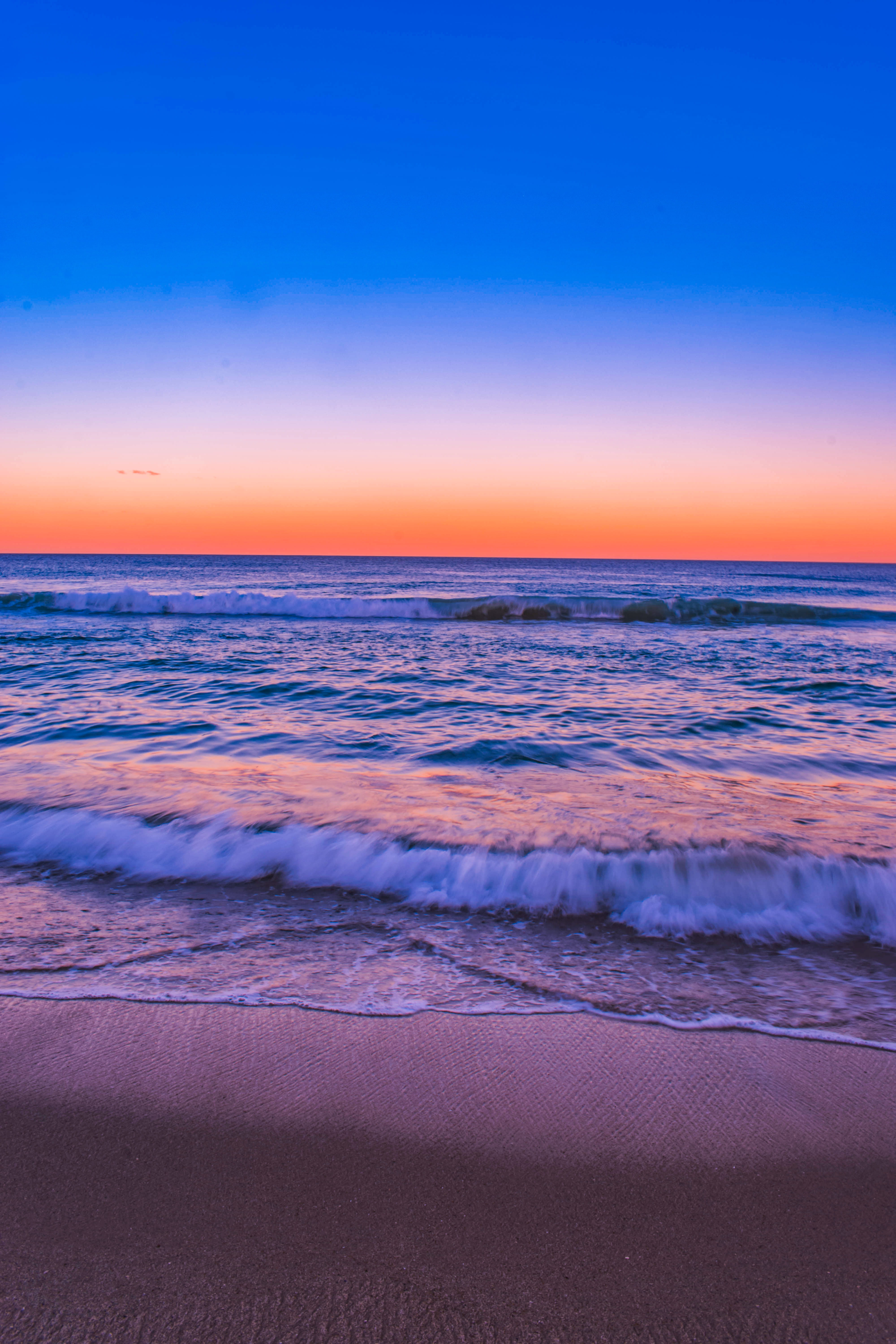 tranquil scene, beautiful, purple, land, wave, sunset, horizon, sport, scenic, sand, sky, seashore, landscape, seascape, seawaves, sea, beach, water, tranquility, Phone HD Wallpaper