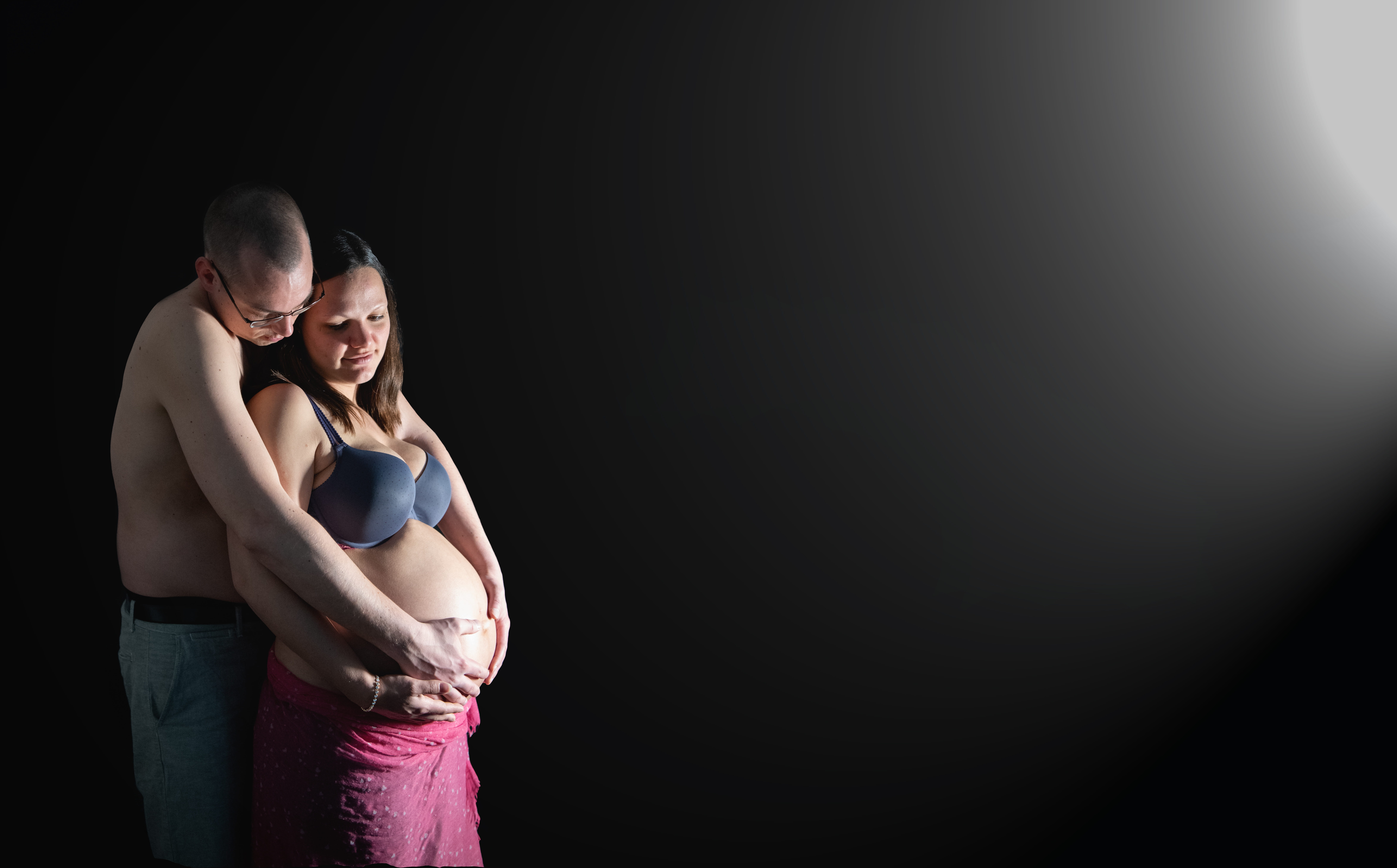 people, black background, two people, bonding, positive emotion, romantic, men, light, adult, baby belly, emotion, birth, indoors, embracing, pregnancy, HD Wallpaper