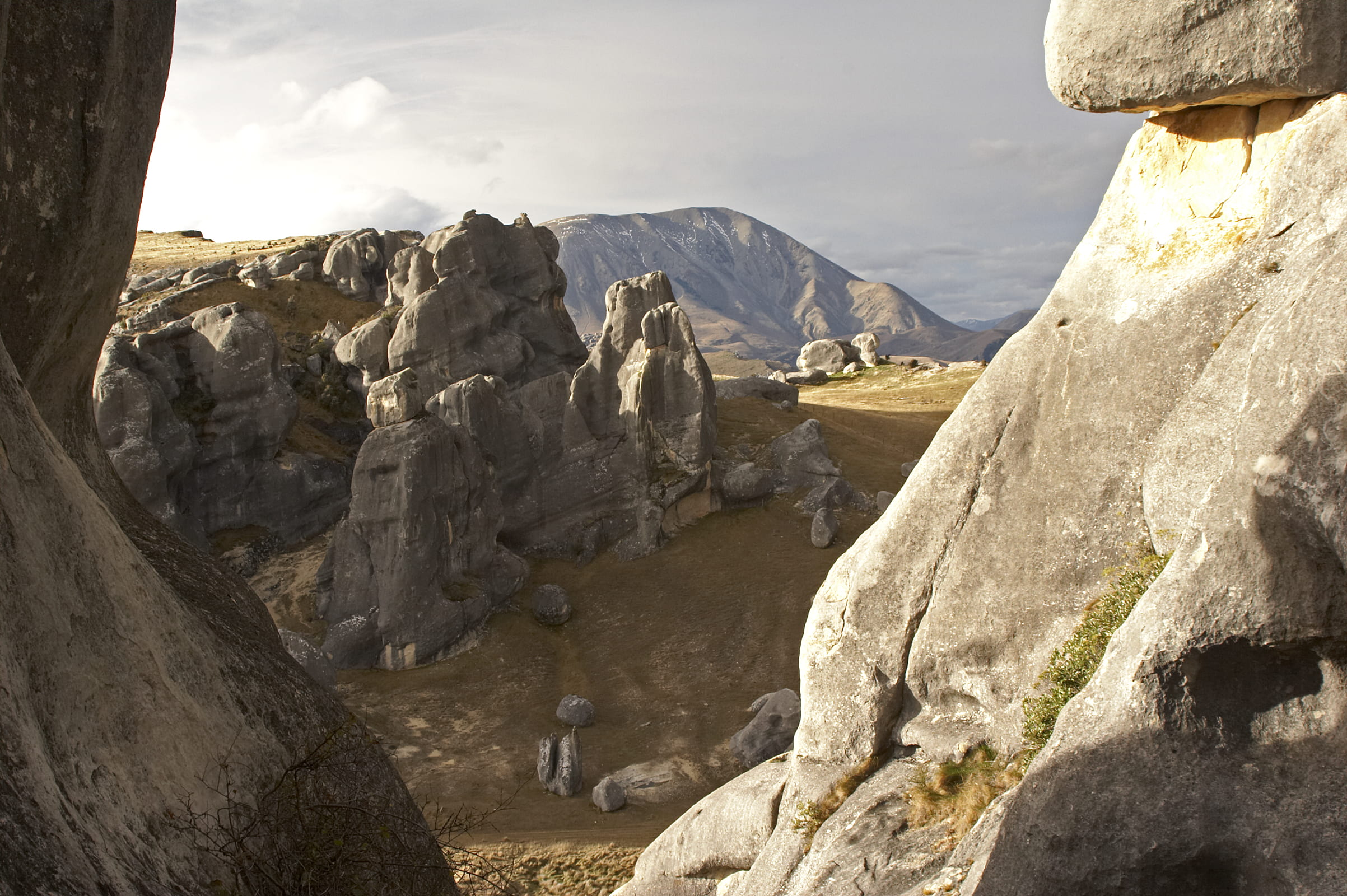 formation, rock, cliffside, outdoors, beauty in nature, new zealand, grass, mountain range, valley, cloud - sky, 1080P, non-urban scene, rock - object, HD Wallpaper