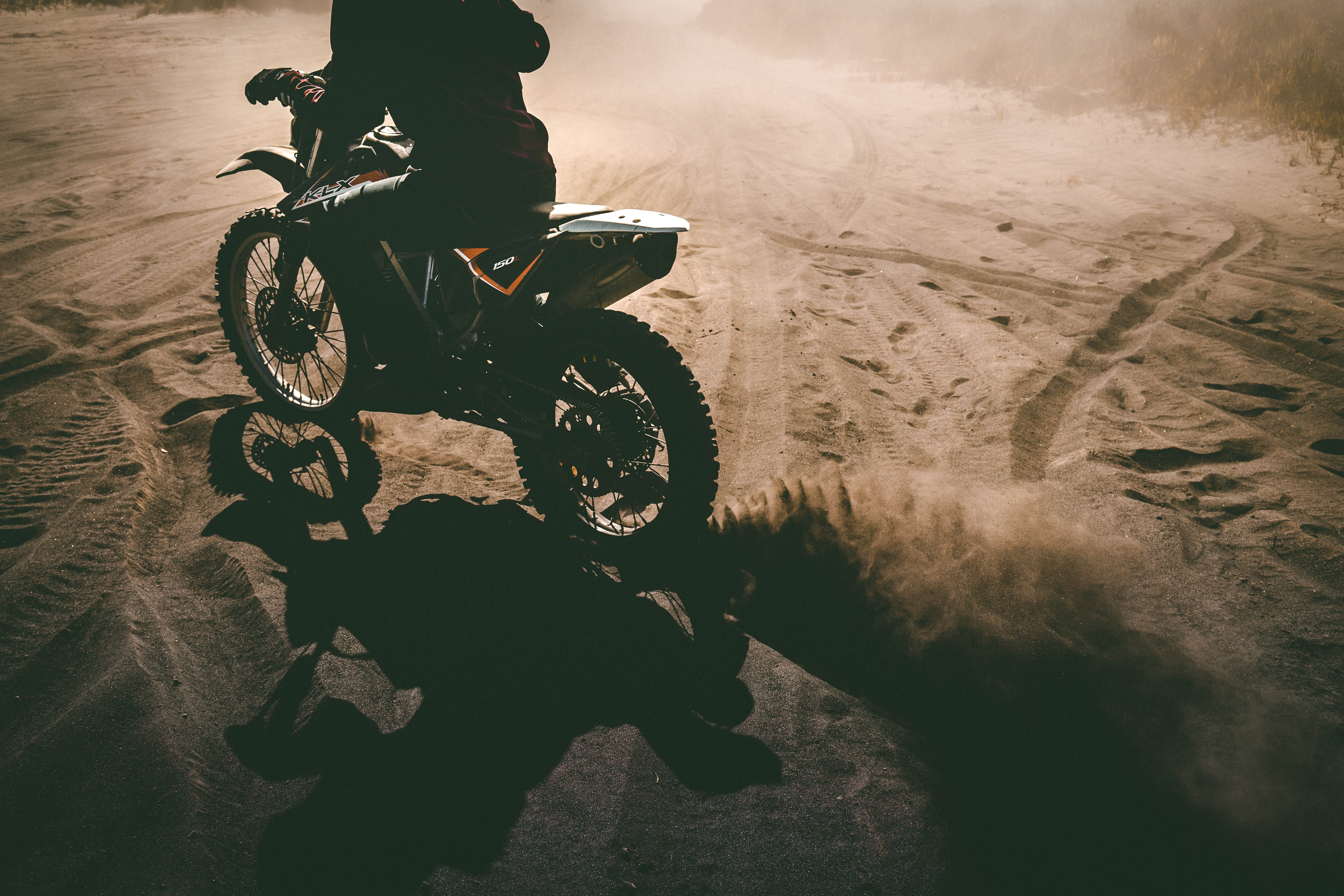 biker, wheel, daytime, dusty, road, mode of transportation, sports helmet, dust, dirt road, dirt, land vehicle, leisure activity, man, outdoor, extreme sports, HD Wallpaper