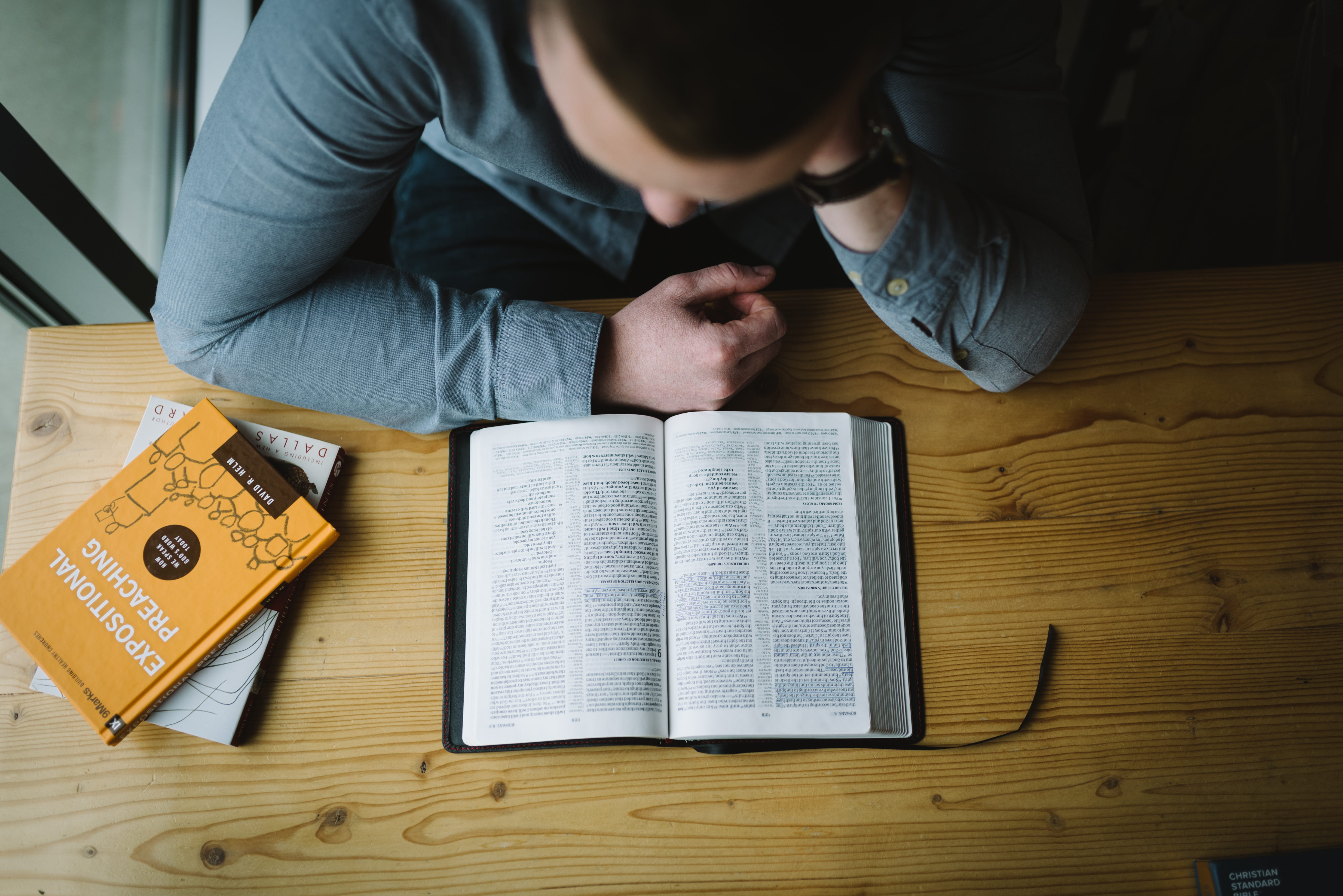 sitting, word of god, read, holding, man, jesu, paper, brown, wooden, man reading, scripture, men, front view, coffee shop, casual clothing, indoors, 5K, HD Wallpaper