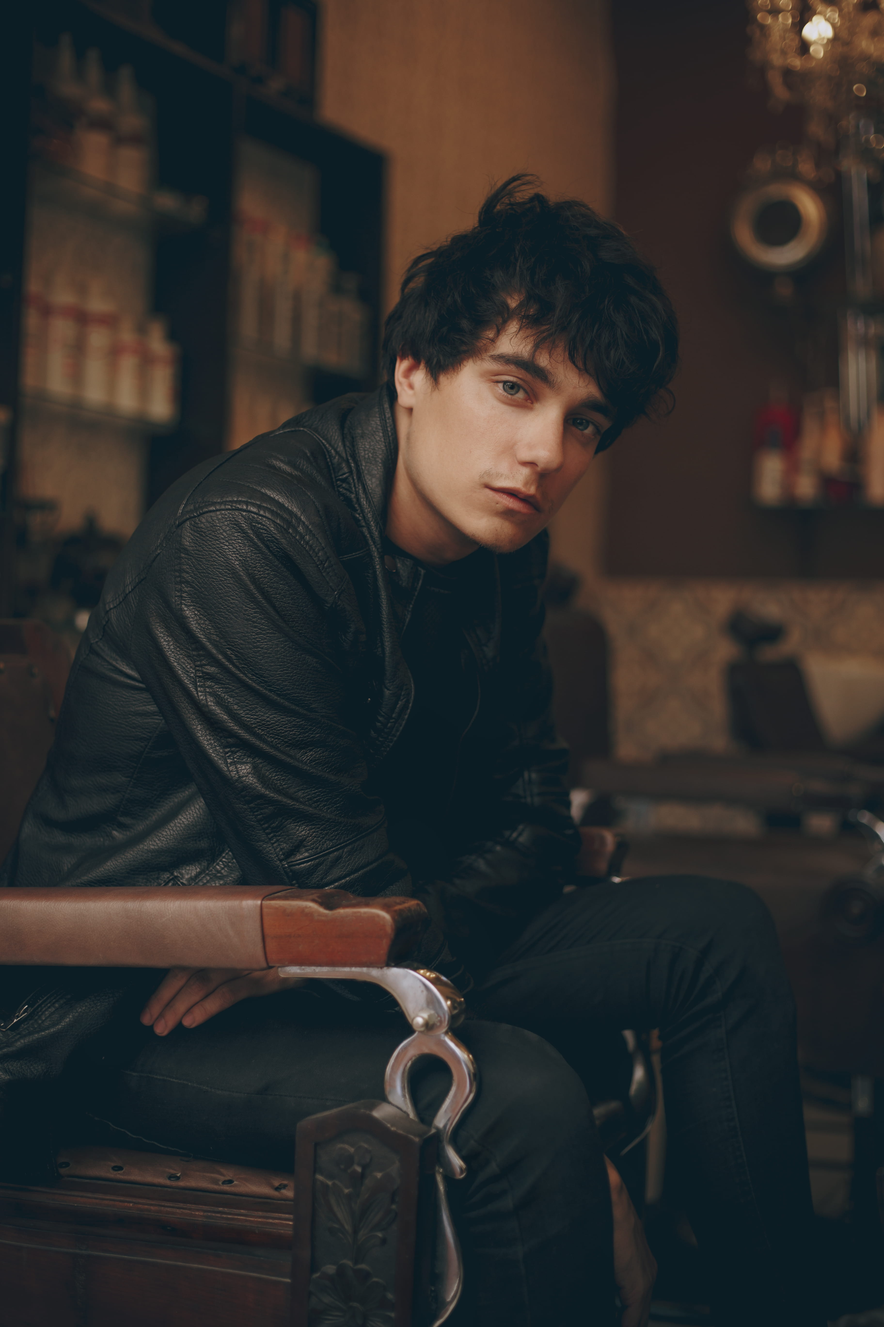 wear, leather, man, fashion, beautiful people, depth of field, 5K, blur, pose, sit, indoors, looking at camera, jeans, attractive, real people, model, Phone HD Wallpaper