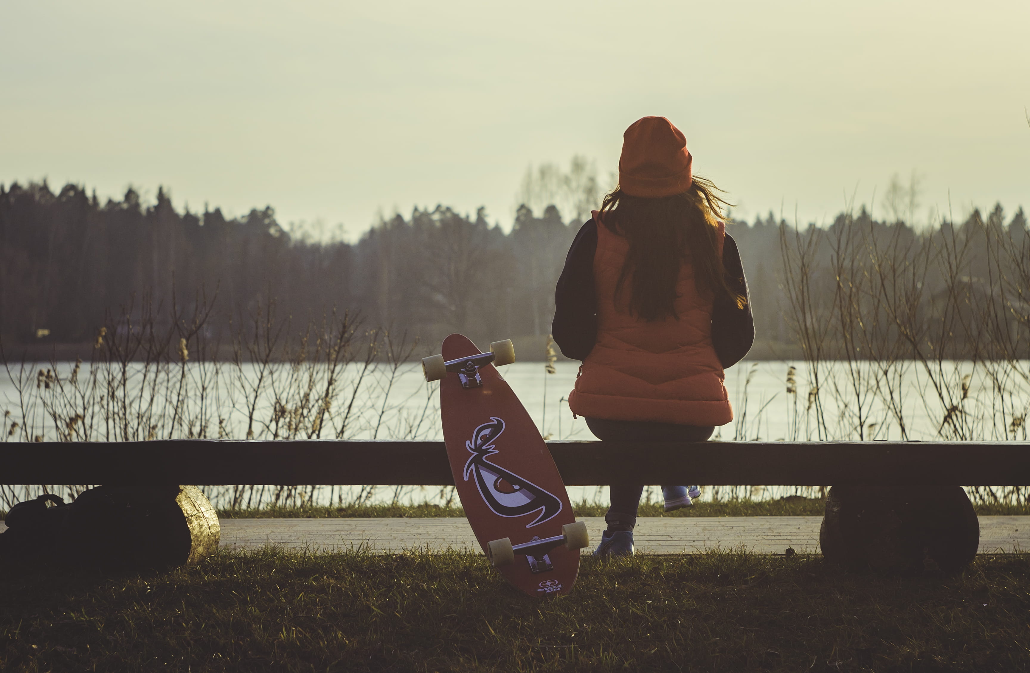 woman in red, lake, tree, caucasian Ethnicity, seat, one woman only, rear view, color Image, skateboard, real people, lifestyles, bag, park bench, looking, HD Wallpaper