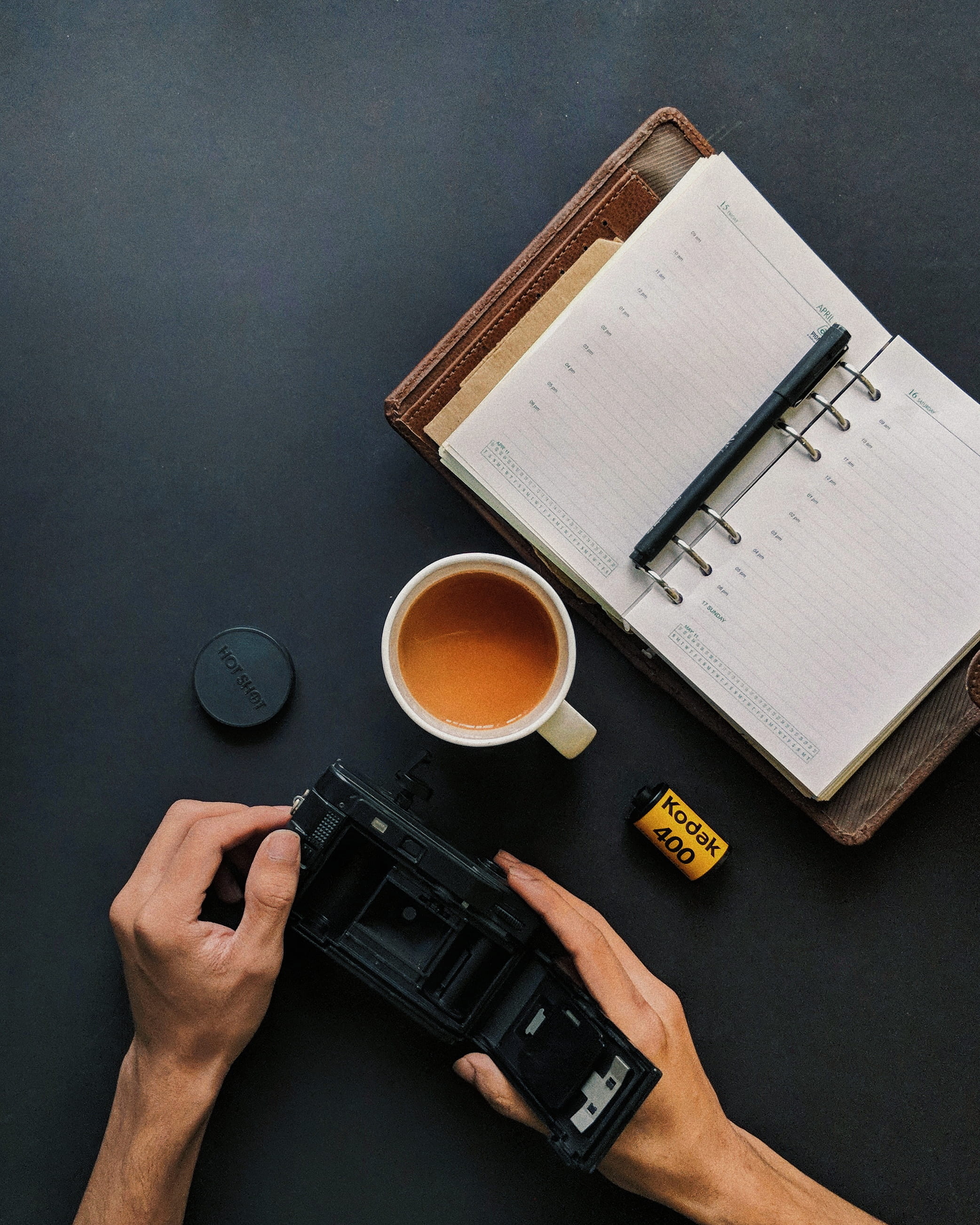hand, holding, planner, tea, human body part, workspace, coffee cup, 2K, people, publication, cup, book, notebook, calendar, table, high angle view, real people, Phone HD Wallpaper