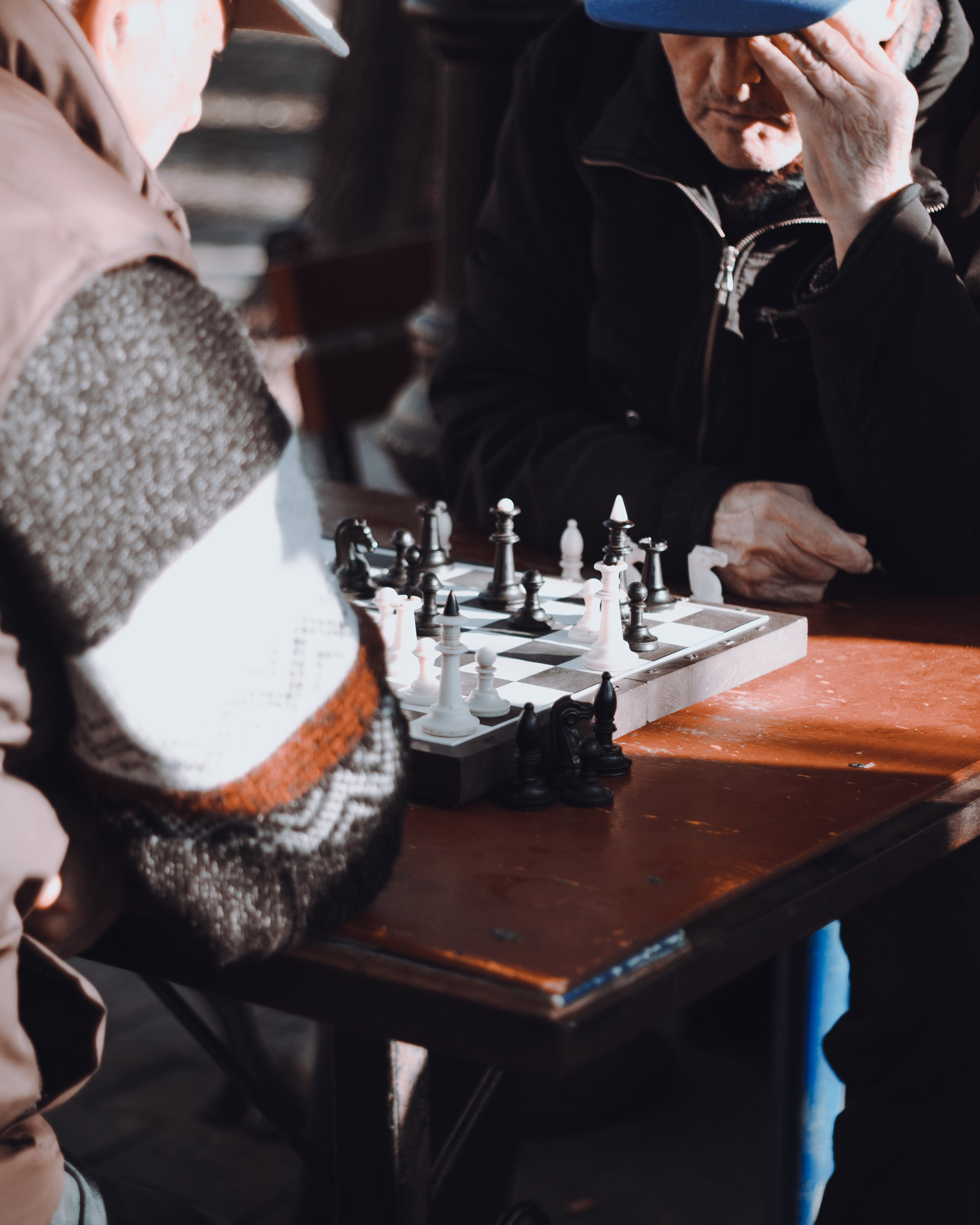 men, indoors, sitting, unrecognizable person, two, lifestyles, playing, real people, human hand, table, selective focus, human body part, crockery, leisure activity, Phone HD Wallpaper