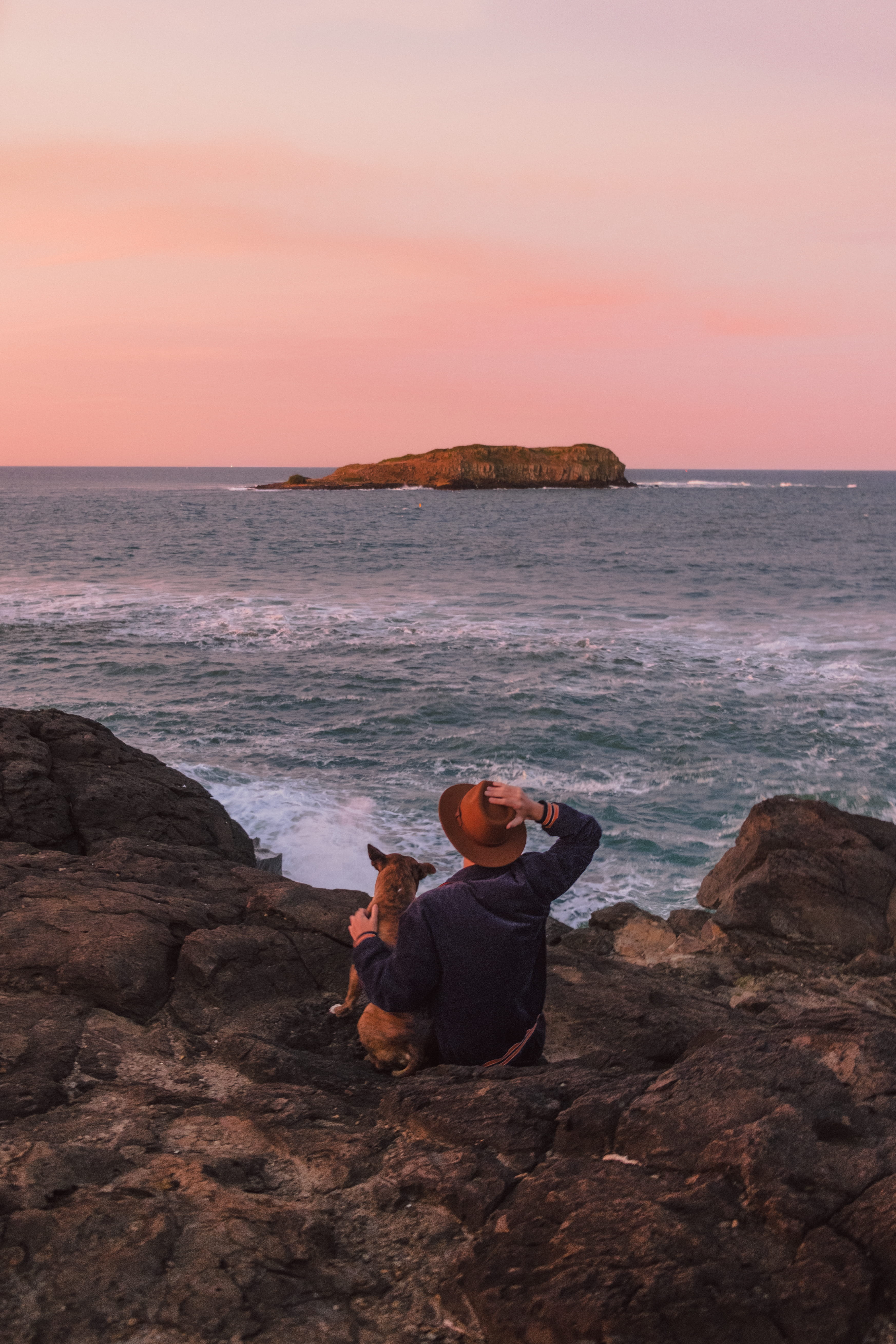 sitting, sea, ocean, bull, folk, magenta, man, hat, rock - object, horizon over water, real people, island, solid, jacket, land, sunset, beauty in nature, Phone HD Wallpaper