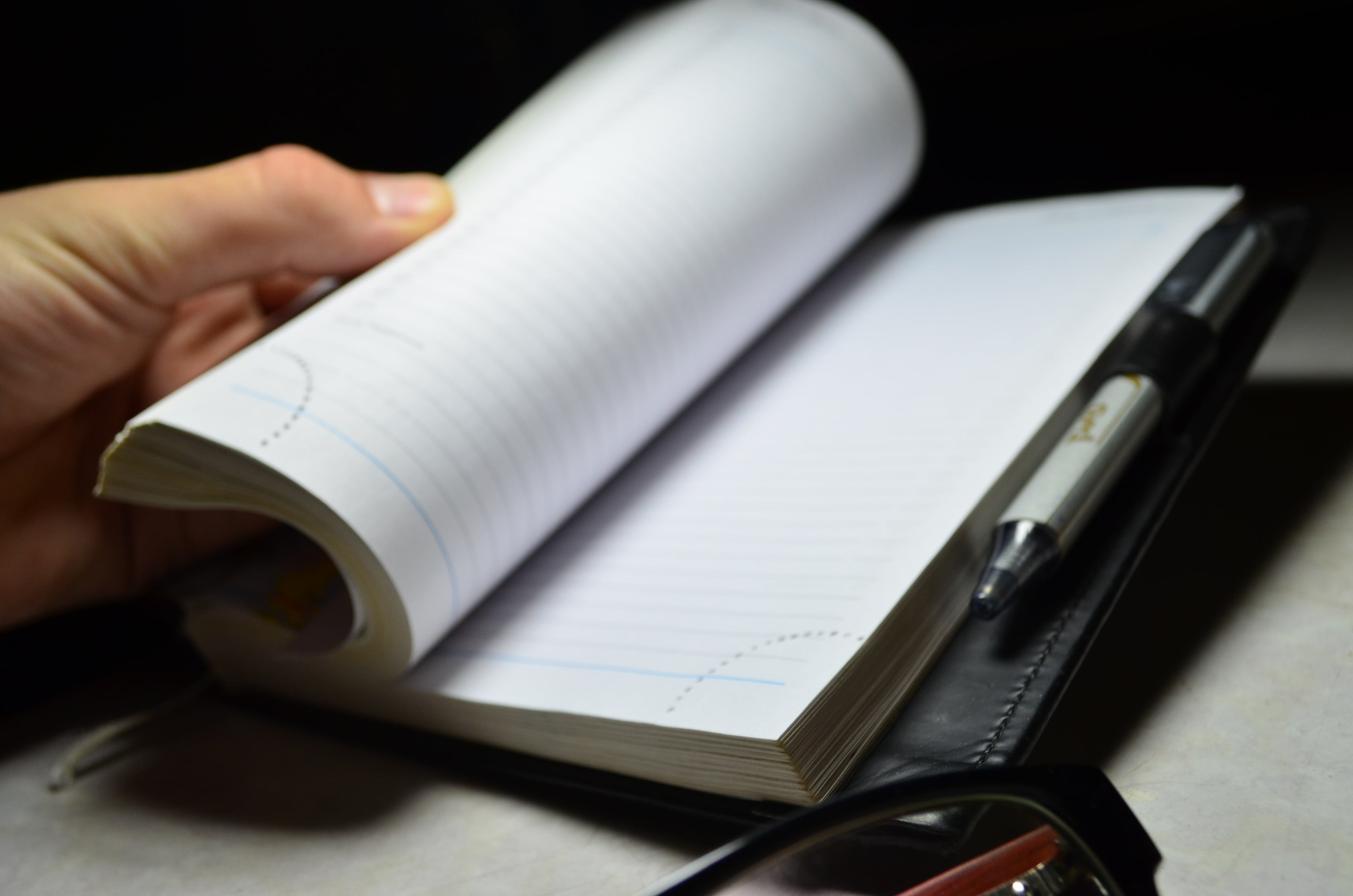 close-up, page, note pad, adult, flipping, negotiations, indoors, 2K, human hand, at work, pen, glasses, business, text, open book, people, black background, HD Wallpaper