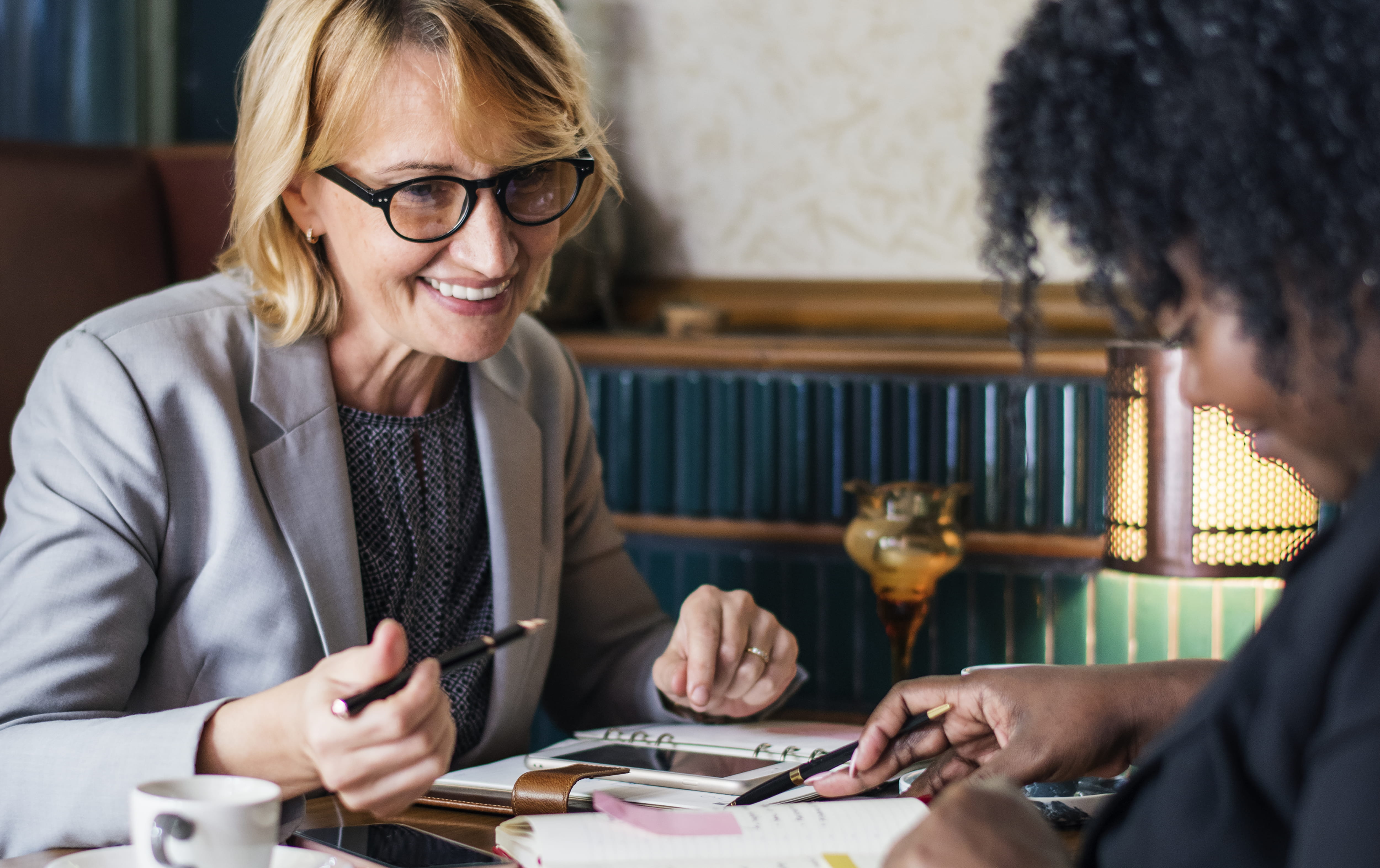 eyeglasses, businesswomen, mature women, women, table, glasses, female, education, smiling, adults, writing, two, two people, work, discussing, discussion, HD Wallpaper