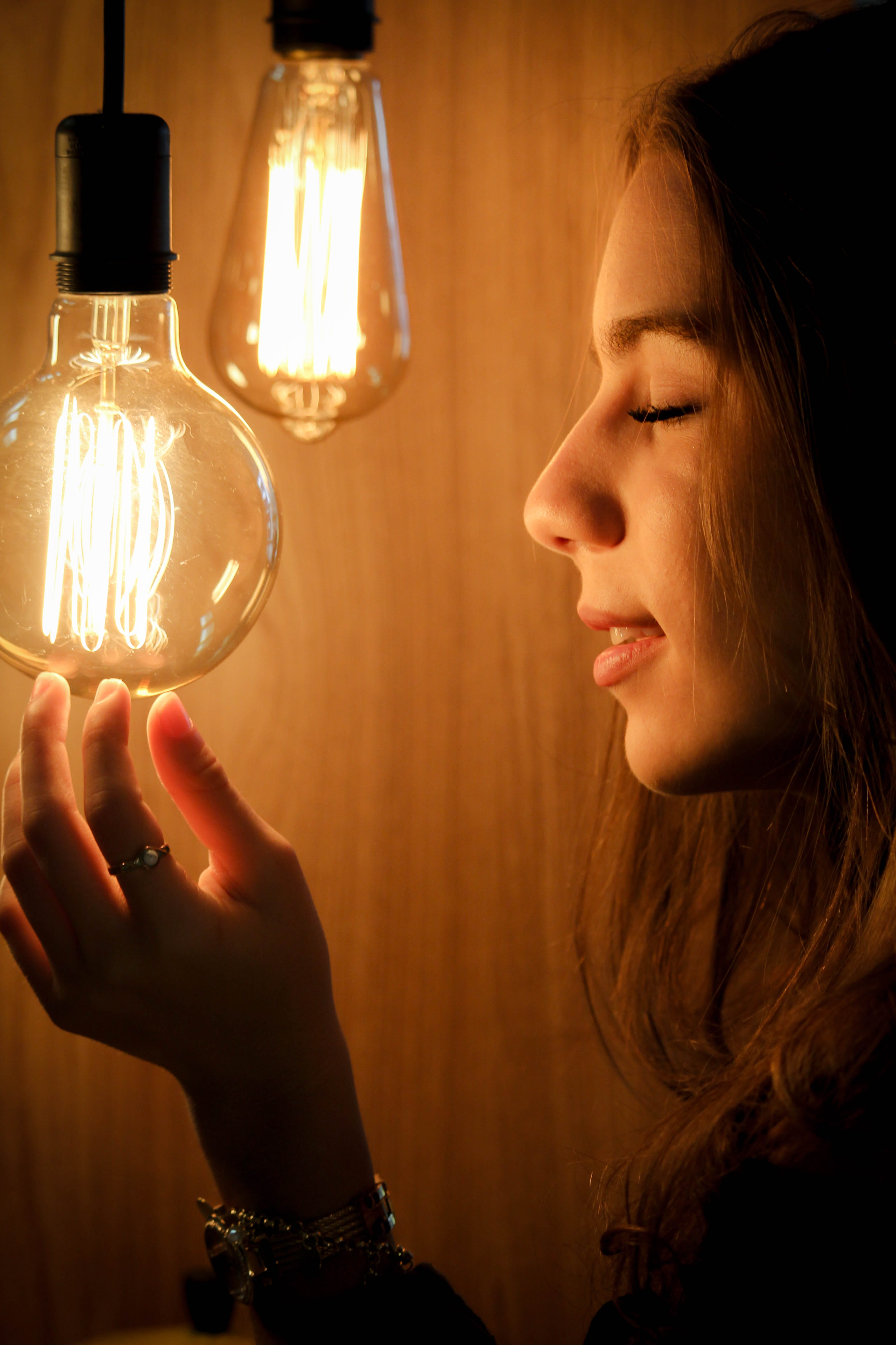 light bulb, hand, adult, headshot, energy, lights, unknown, electric lamp, light glare, women, photoshoot, facing, bulb, technology, pose, lighting equipment, Phone HD Wallpaper