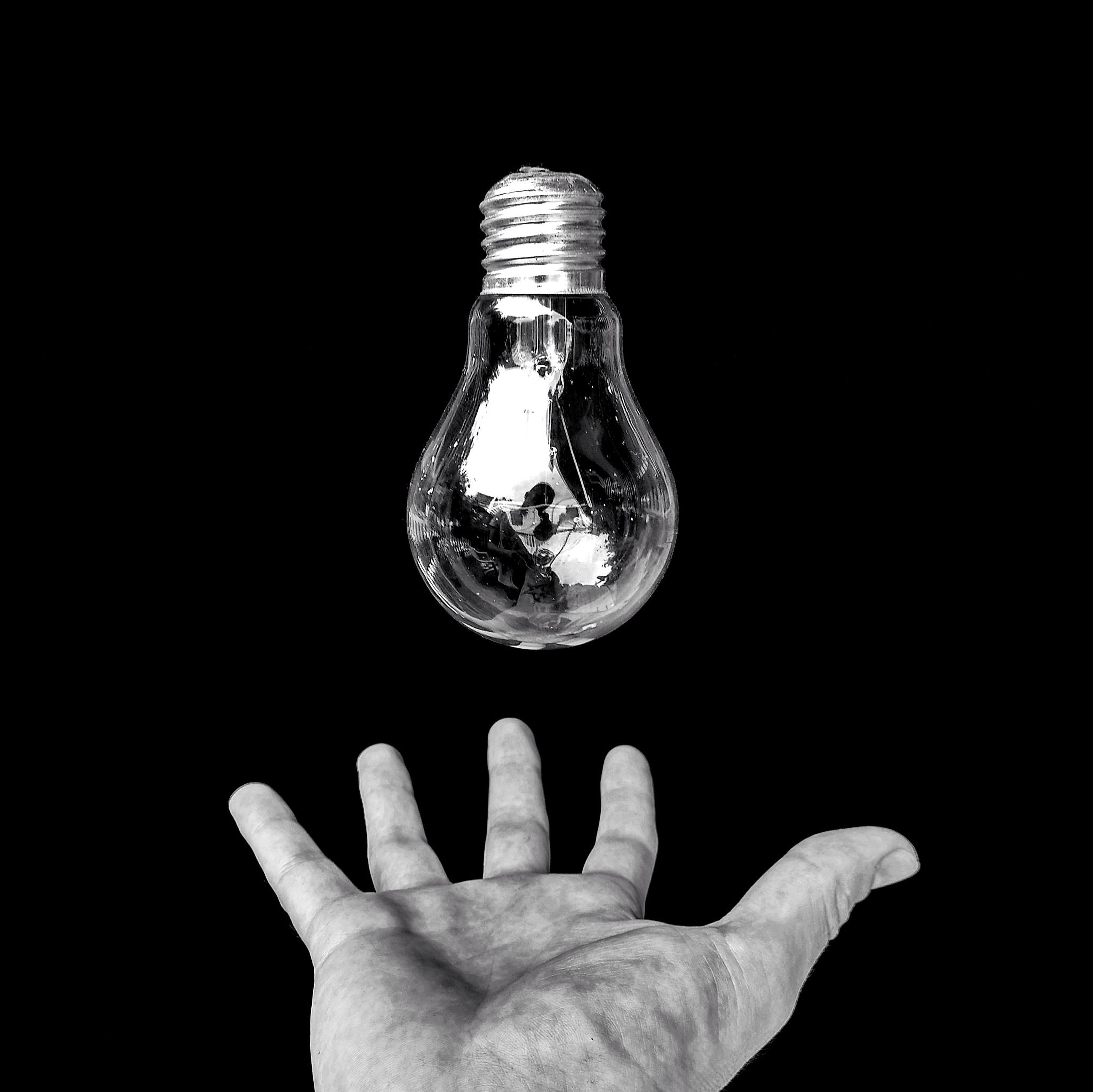 cut out, lighting equipment, studio shot, energy, one person, unrecognizable person, design, black background, close-up, light bulb, 4K, human finger, HD Wallpaper