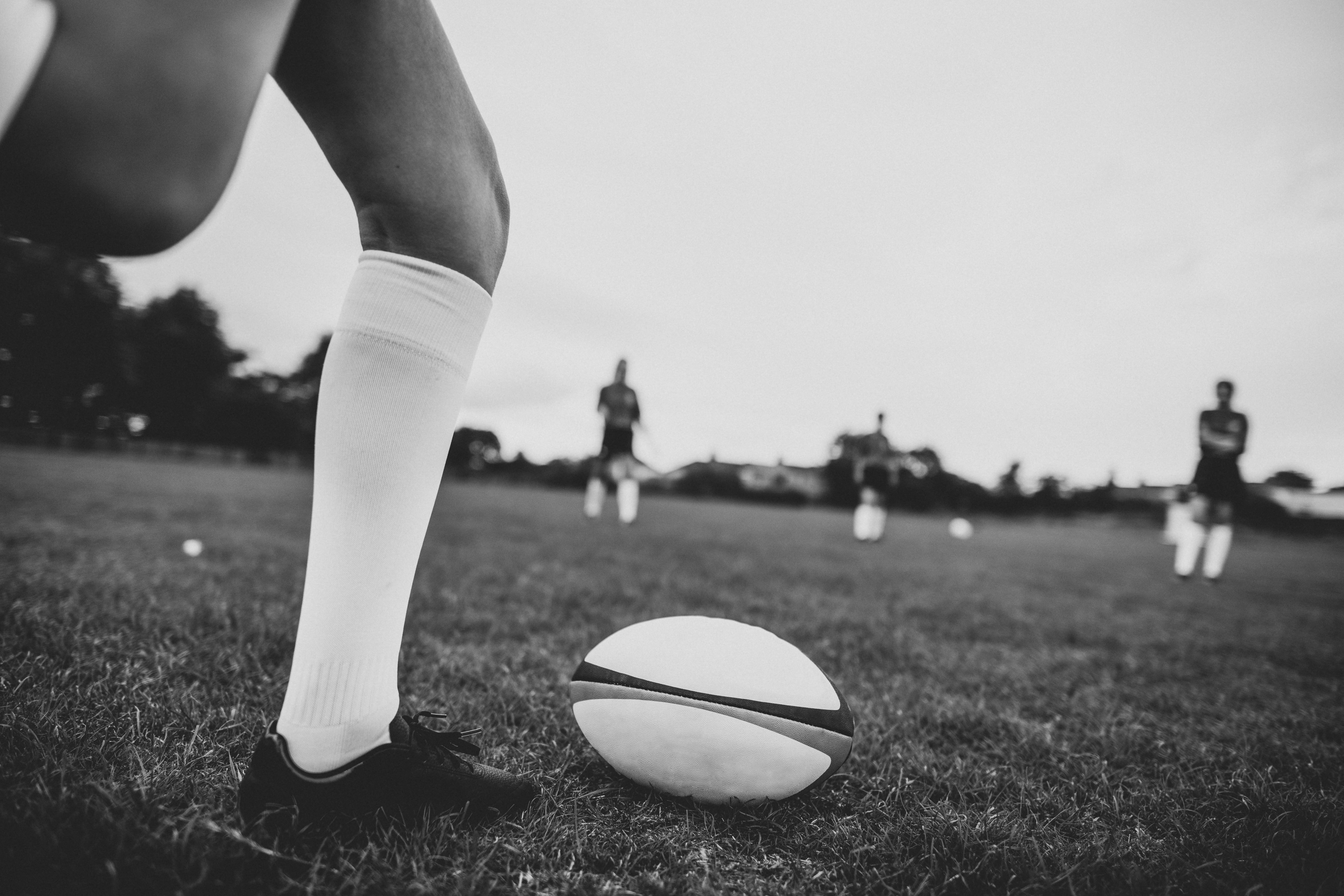 unrecognizable person, legs, leisure activity, footwear, grass, game, uniform, field, black and white, sporty, day, feet, sports equipment, players, together, HD Wallpaper