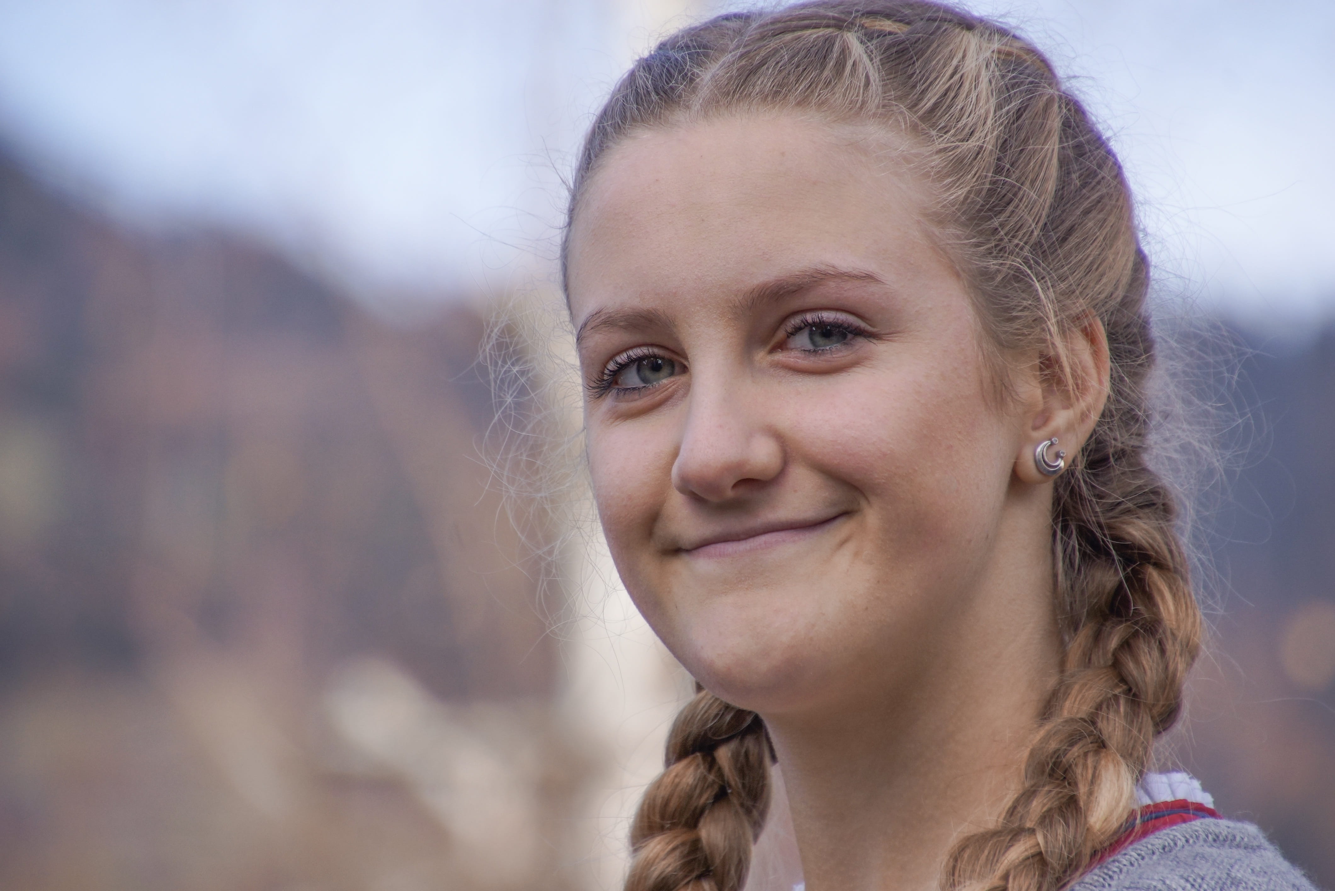 smiling, outdoors, human face, portrait, emotion, 4K, braids, courageous, strong, looking at camera, optimistic, focus on foreground, nature, woman, front view, HD Wallpaper