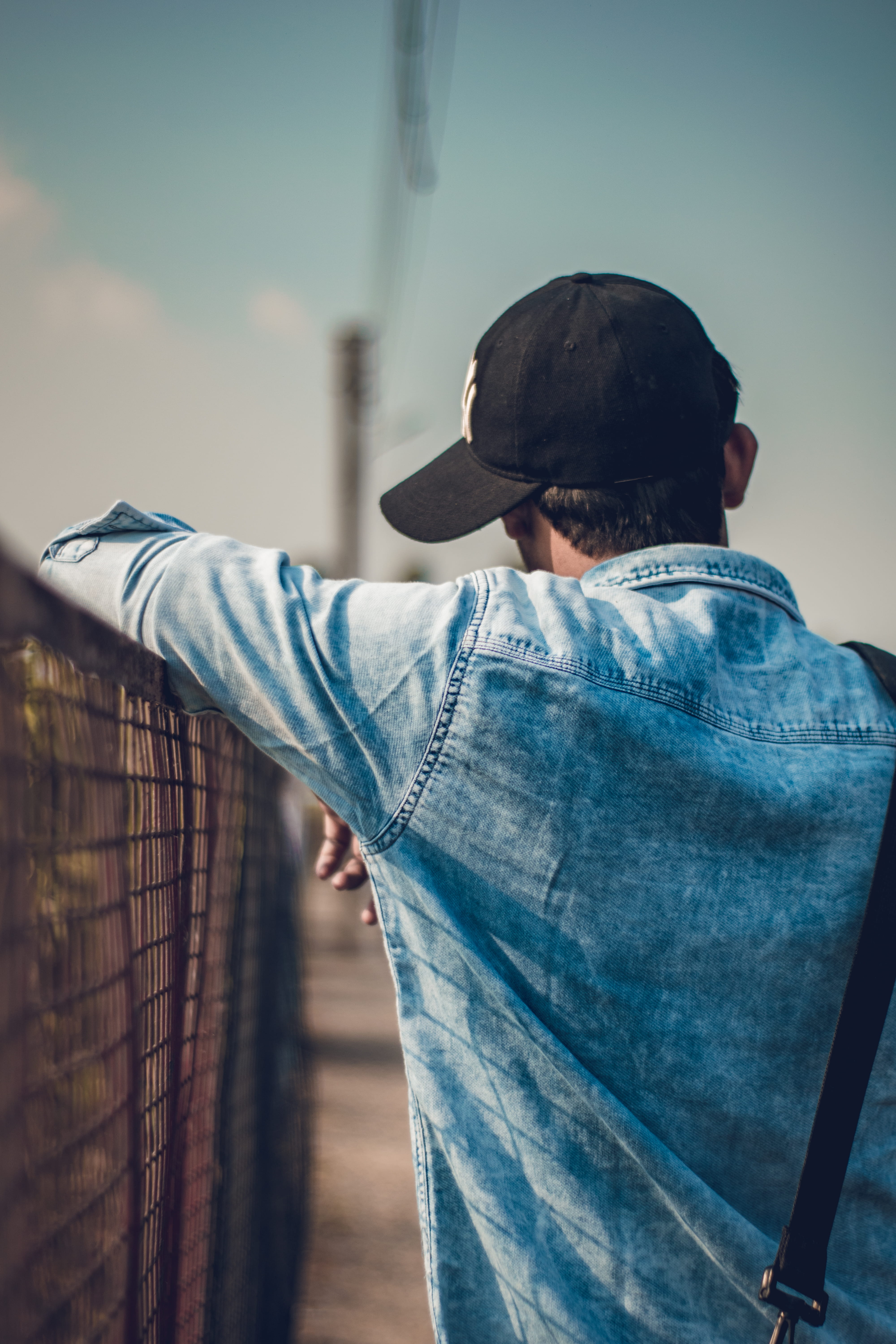 wear, blue, street, clothing, young adult, real people, male, leisure activity, day, hat, standing, men, fence, casual clothing, daylight, rear view, man, Phone HD Wallpaper