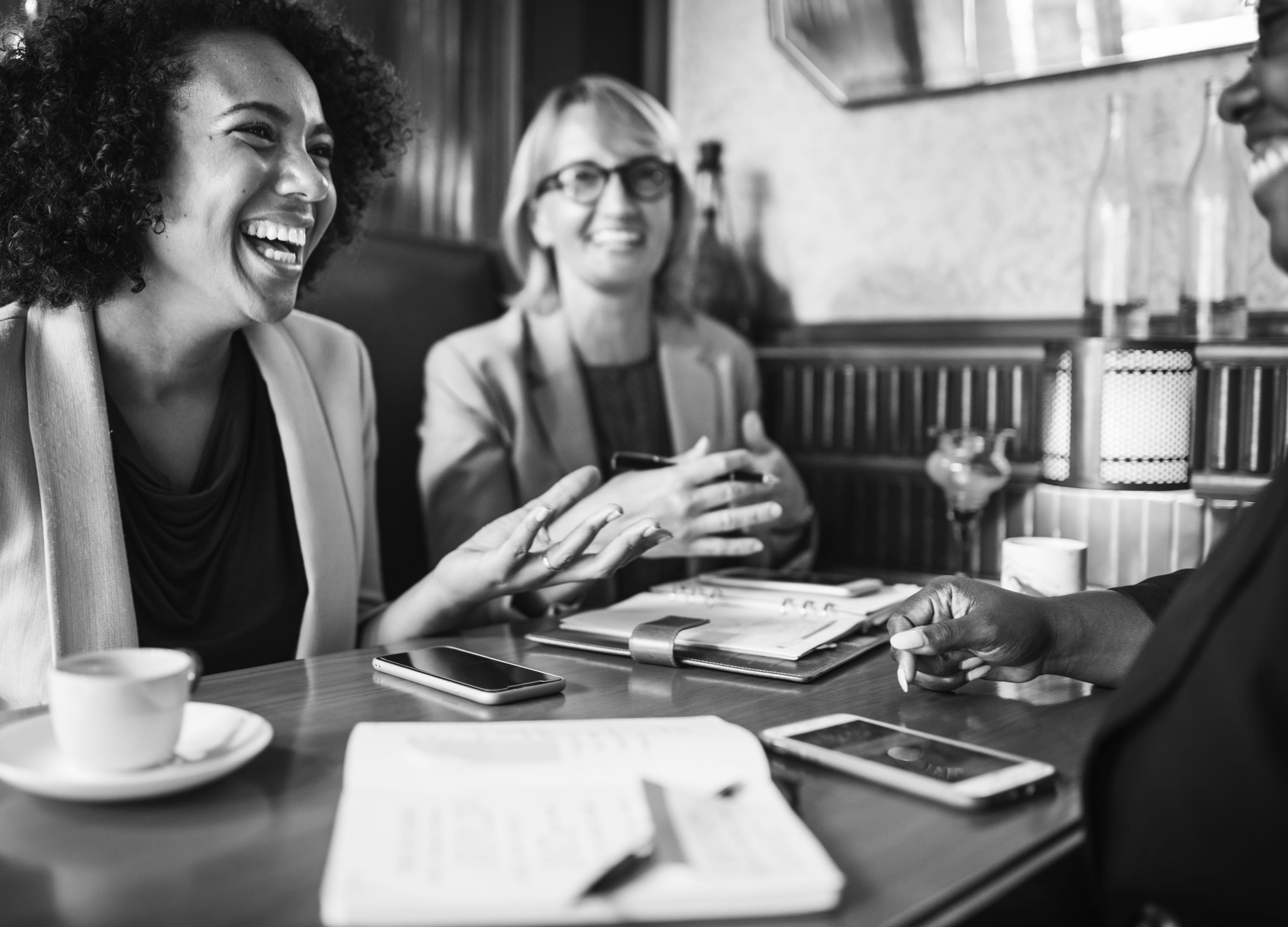 black-and-white, indoors, 2K, grayscale, happiness, photo, women, planning, notebook, adult, smiling, real people, communication, people, young men, coffee, HD Wallpaper