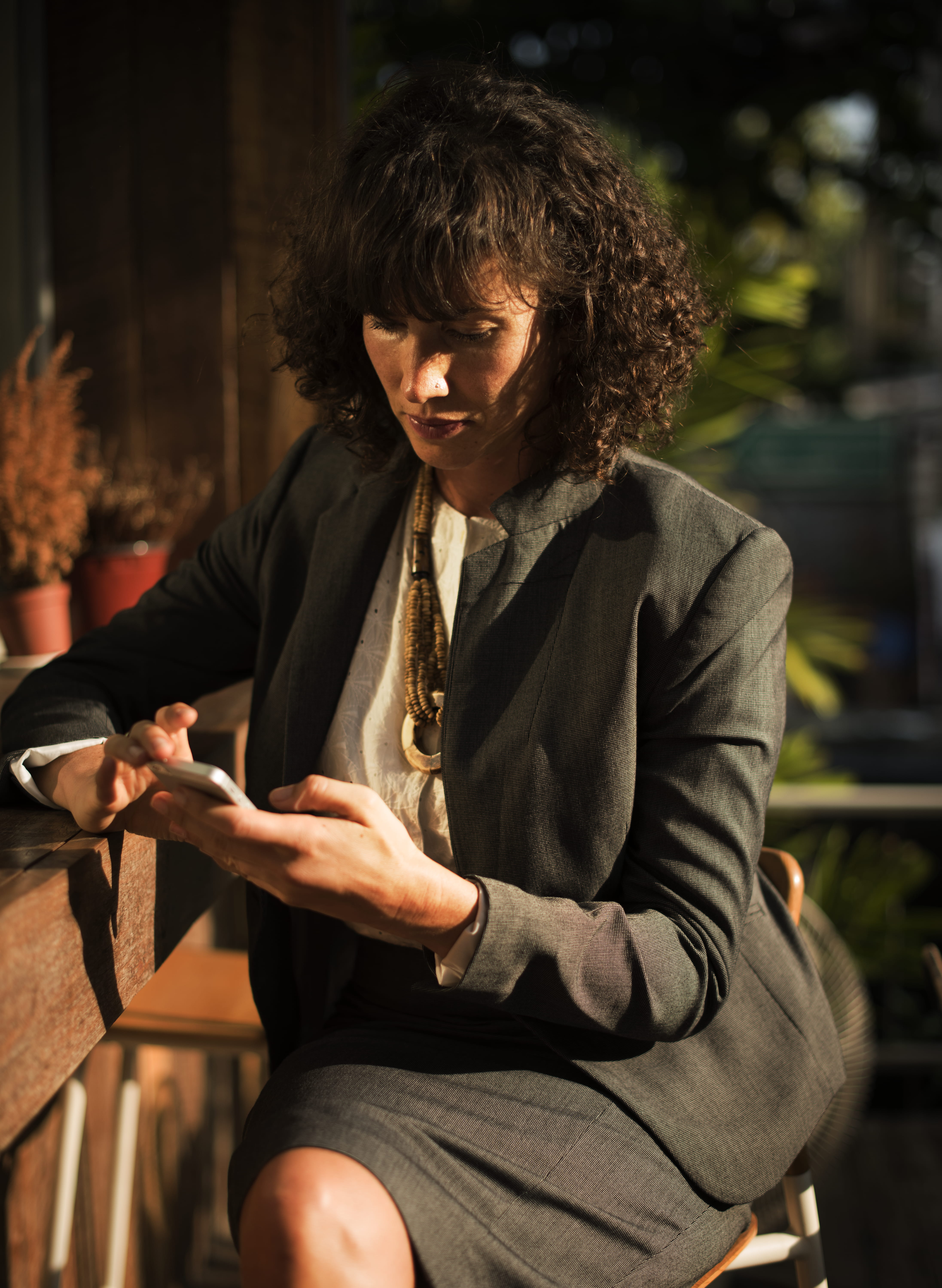 front view, businesswoman, phone, three quarter length, day, on the phone, holding, lifestyles, leisure activity, stool, smartphone, businessperson, clothing, Phone HD Wallpaper