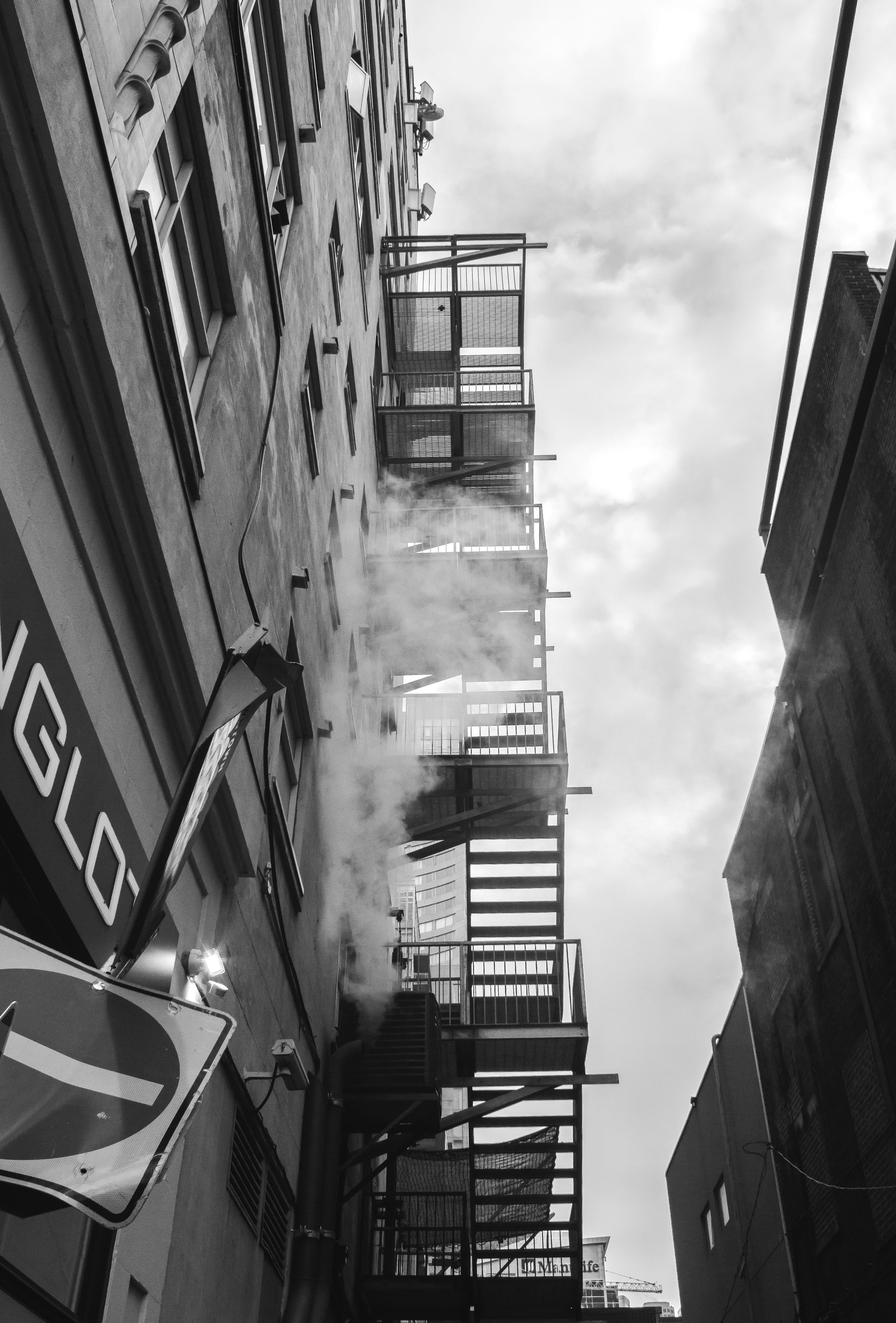 smoke, 4K, building exterior, iron, tall - high, emergency, architecture, urban, cloud - sky, window, access, nature, dark, steel, house, external, low angle view, Phone HD Wallpaper