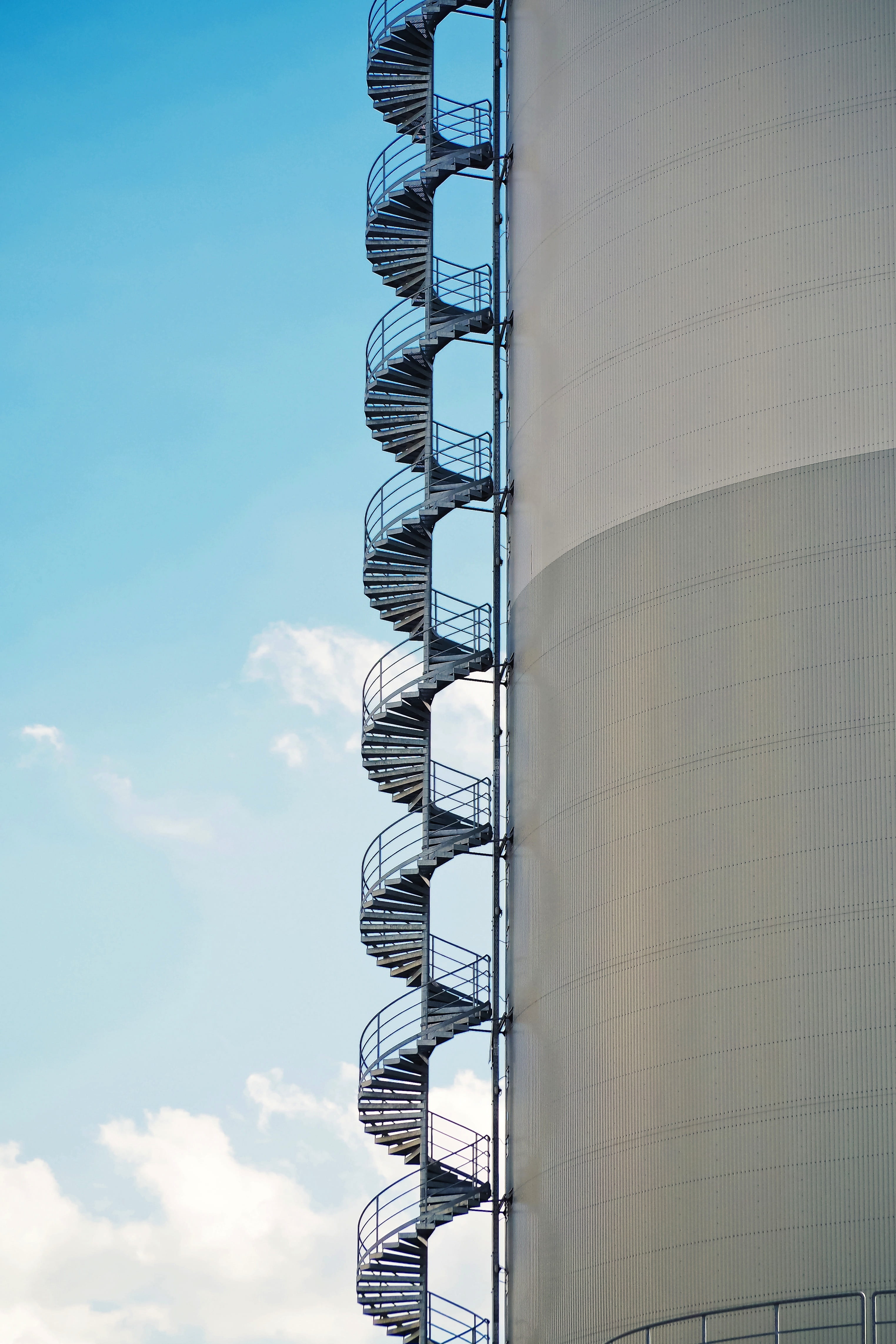 sunlight, spiral staircase, industrial building, geometry, building exterior, 4K, staircase, built structure, perspective, fire escape, low angle view, Phone HD Wallpaper