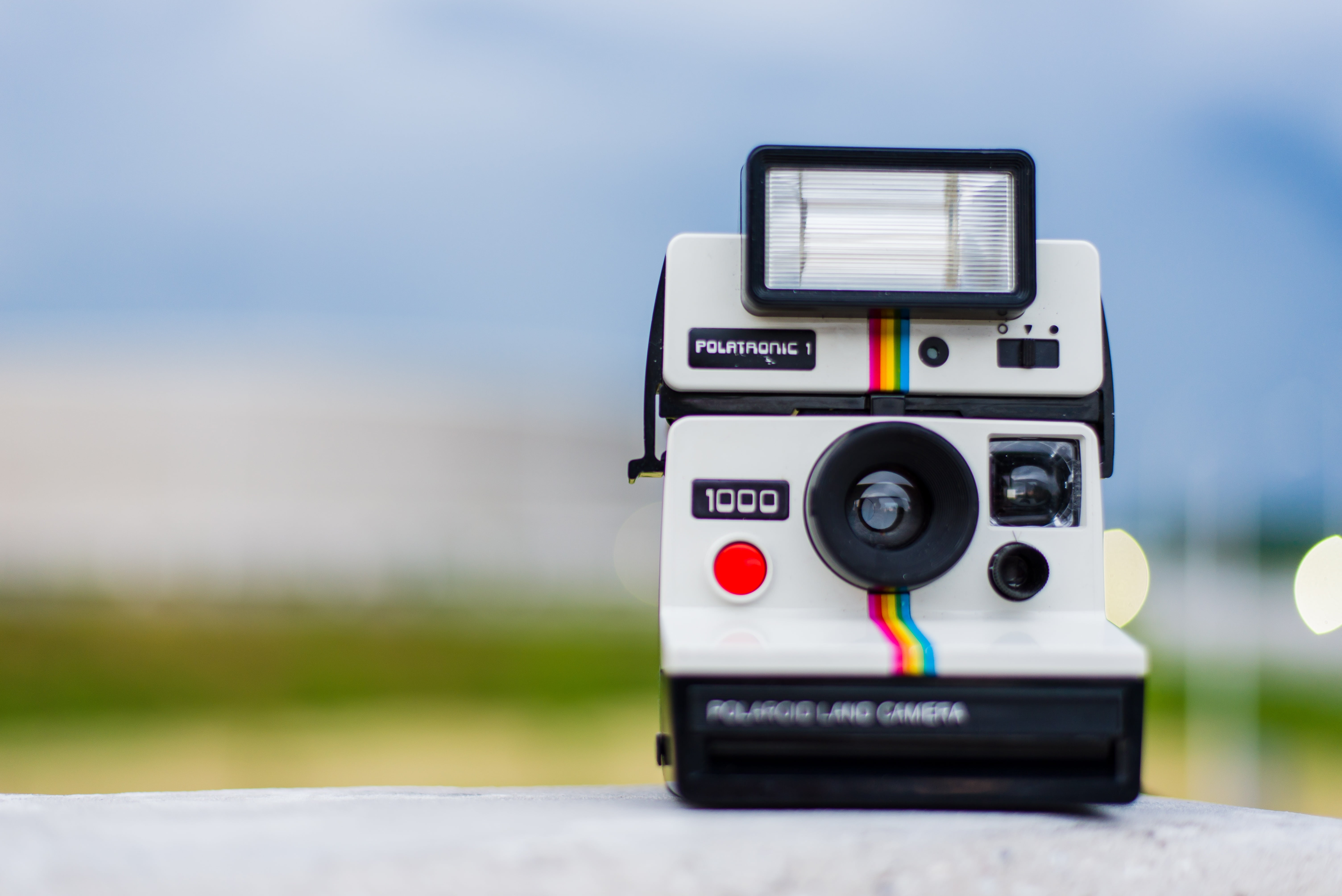 focus on foreground, flash, grass, 5K, travel, workplace, camera - Photographic Equipment, set, landscape, camera, polaroid, close-up, land, black, skyline, HD Wallpaper