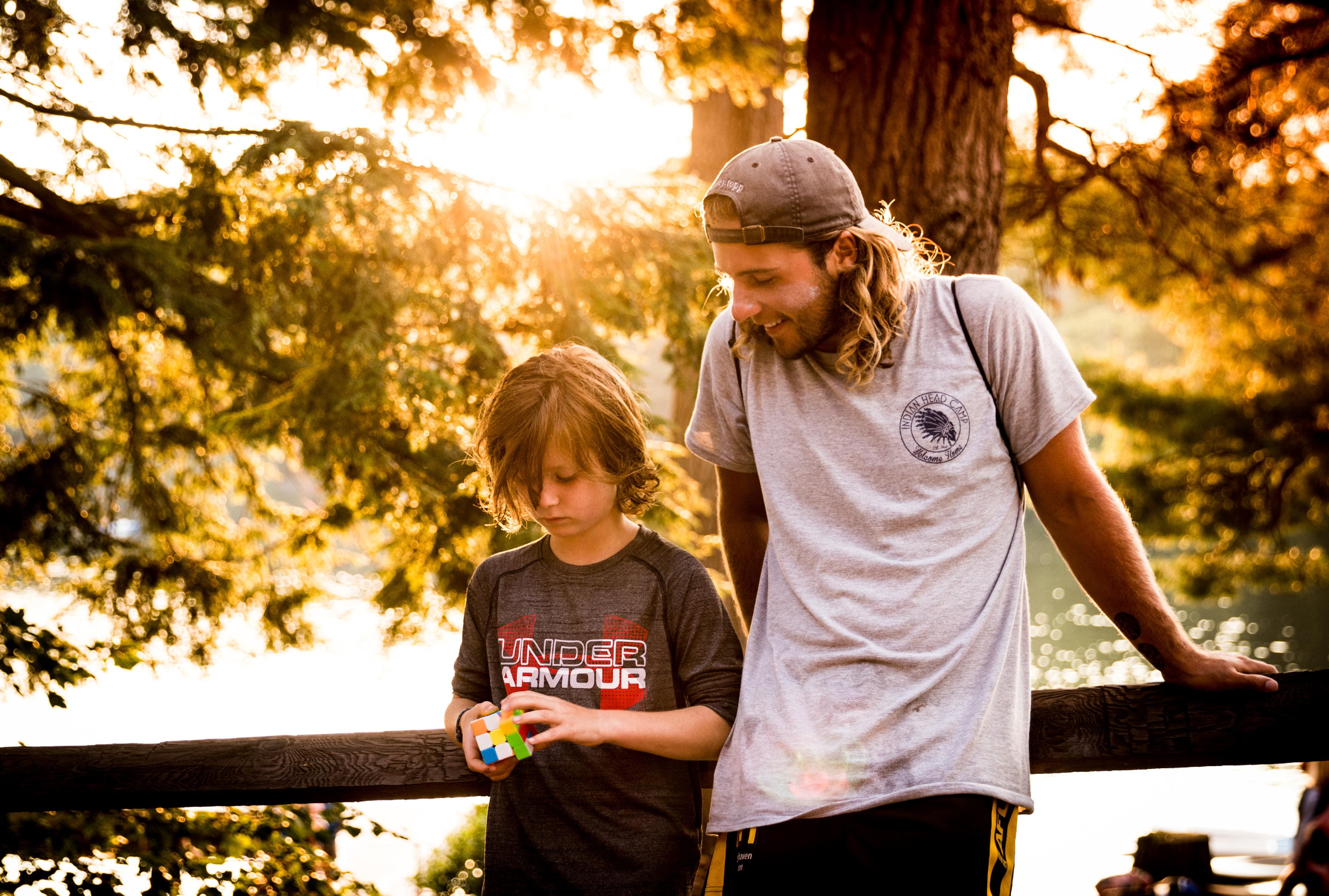 cap, two people, adult, lifestyles, equinunk, togetherness, childhood, sleeve, playing, lens flare, plant, casual clothing, beside, boys, camp ihc, real people, HD Wallpaper