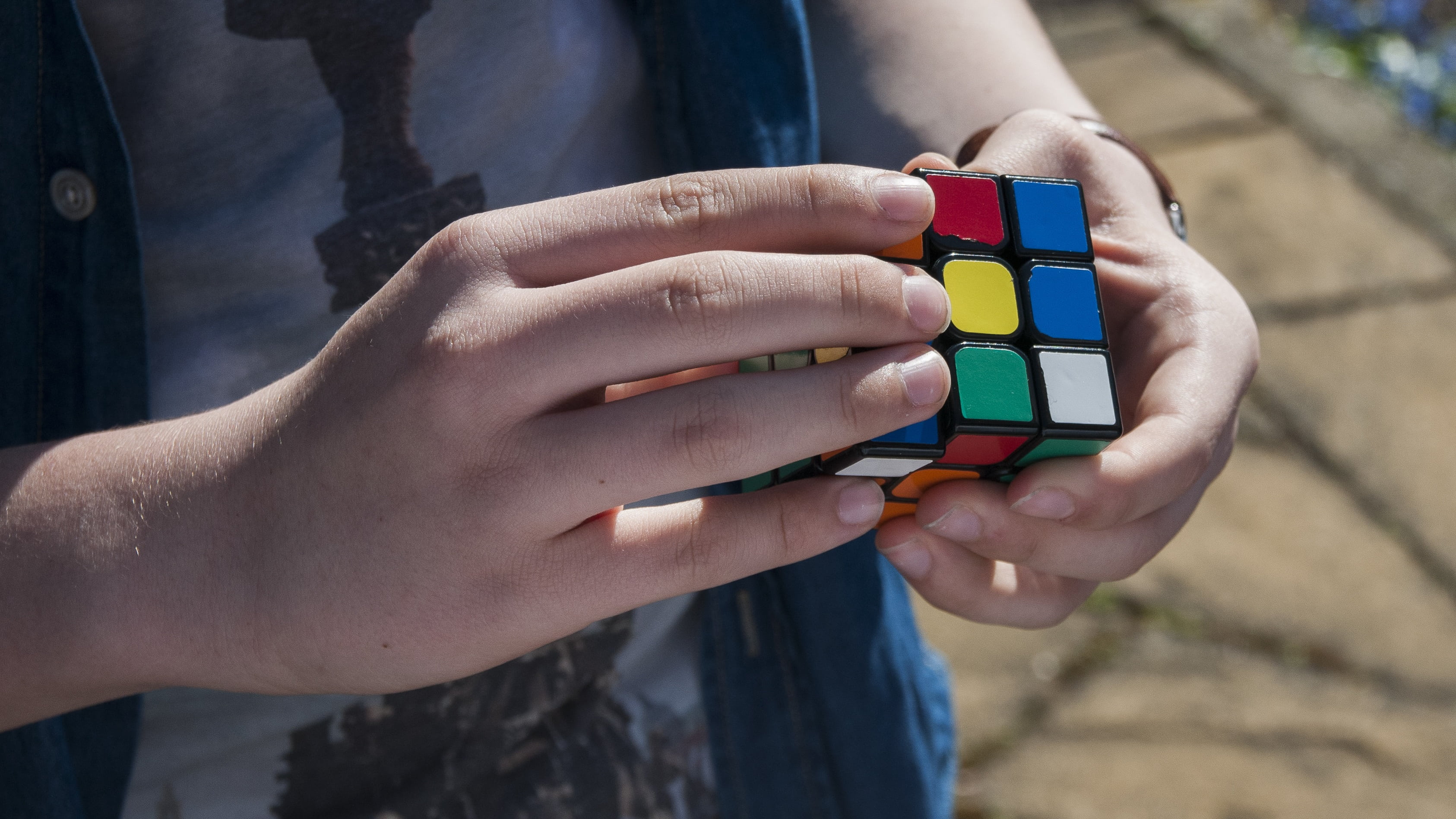 multi colored, hand, people, cube, rubik, adult, holding, outdoors, one person, young adult, one woman only, day, women, youth, fingers, focus on foreground, HD Wallpaper