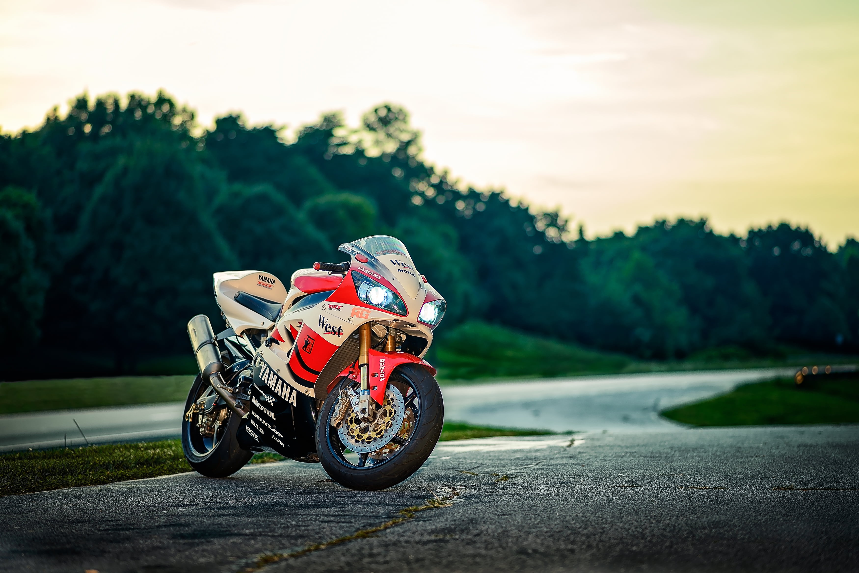 motorcycle Racing, focus on foreground, land vehicle, paddock, motorcycle Grand Prix, professional Sport, tree, cycling, multicolored, red, sports helmet, HD Wallpaper