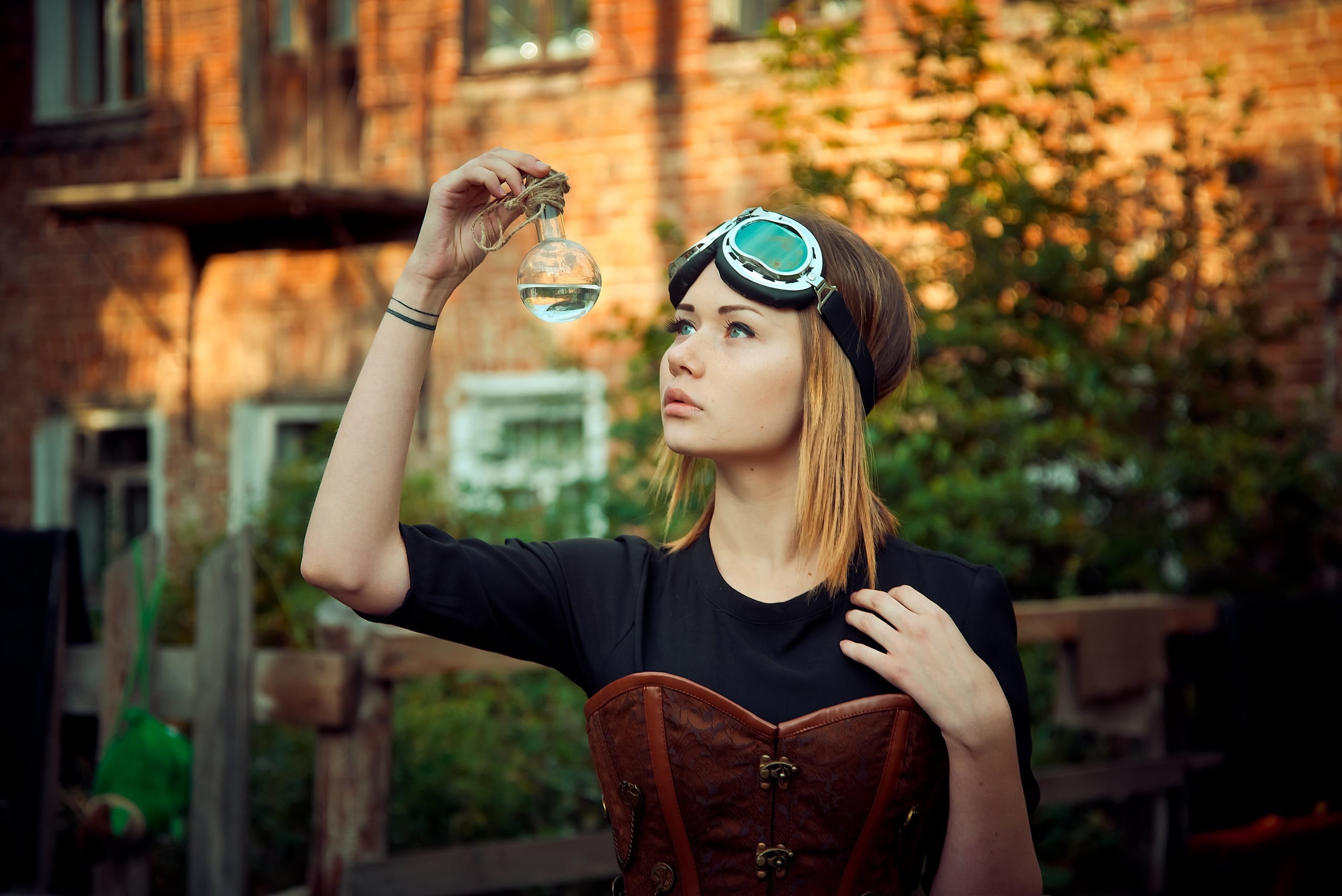 real people, young adult, black dress, tree, casual clothing, fashion, steampunk, blonde, plant, lifestyles, depth of field, green eyes, outdoors, holding, HD Wallpaper