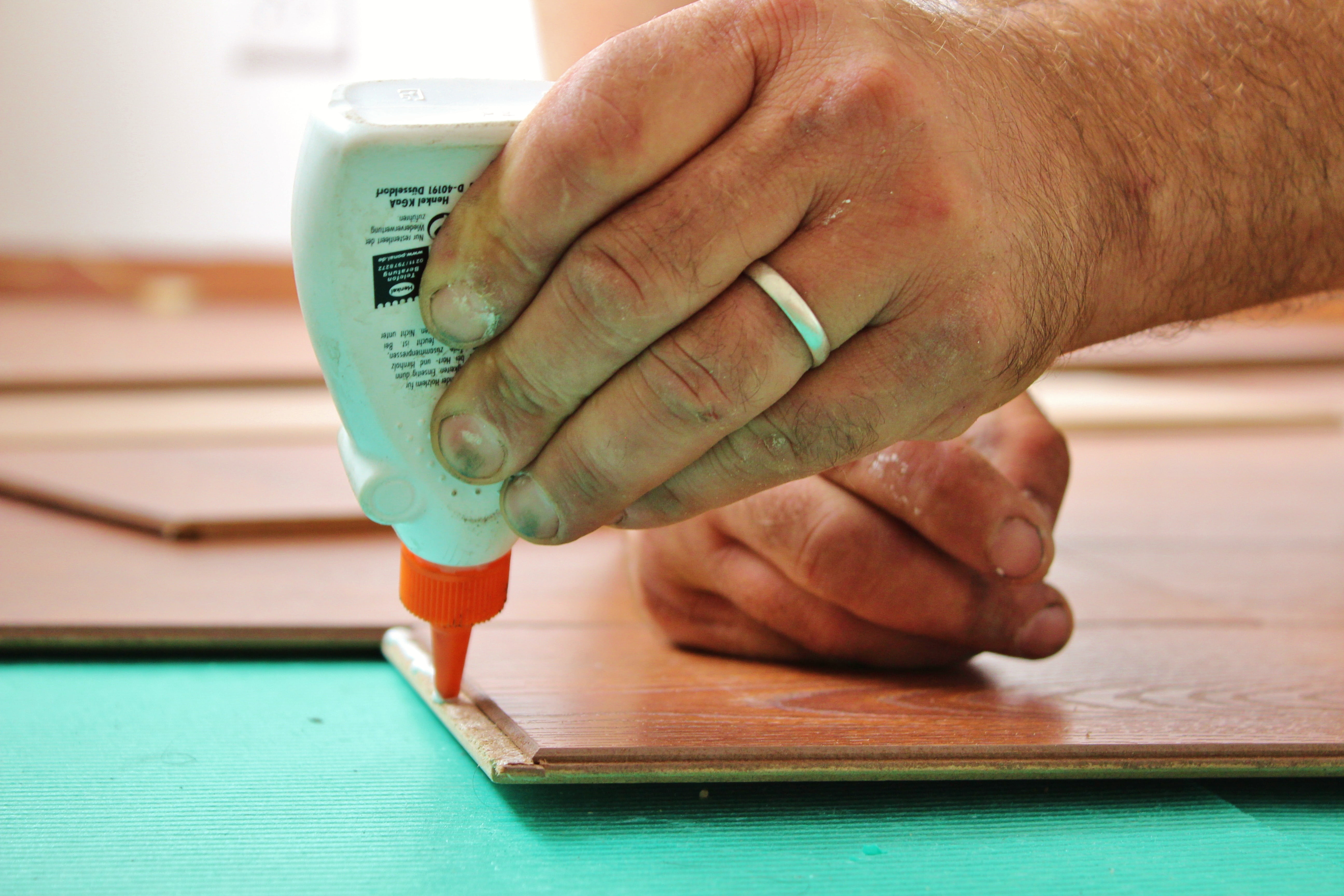 glue, wood glue, business, work, person, table, holding, green color, human finger, indoors, hand, man, body part, finance, plastic, focus on foreground, HD Wallpaper