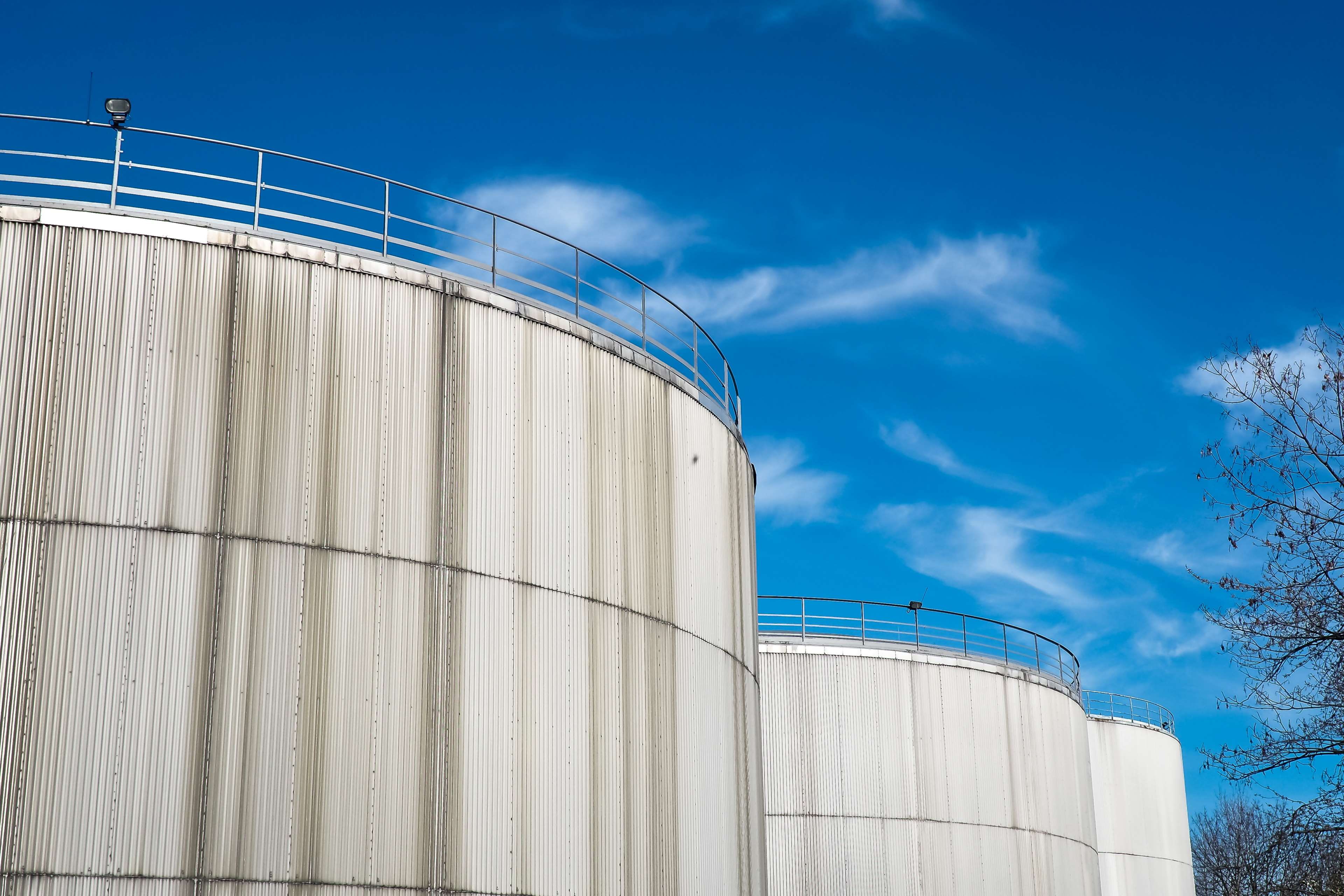 fuel storage tank, steel, outdoors, low angle view, blue, gasoline tanks, architecture, inland port, storage tank, cloud - sky, fuel, industrial plant, HD Wallpaper